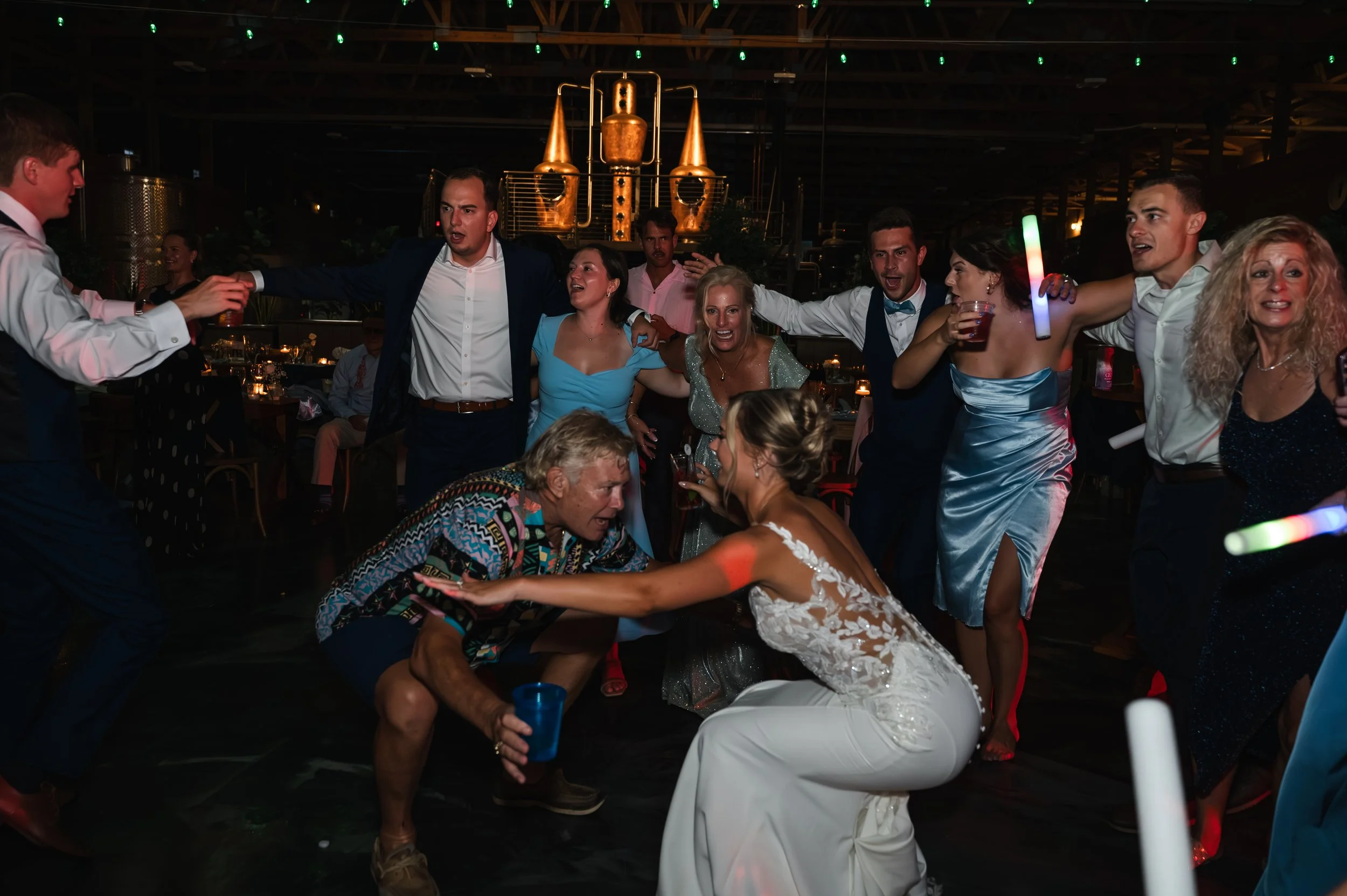 Sydney dances with guests on the crowded dance floor at her Gypsy Distillery wedding reception.