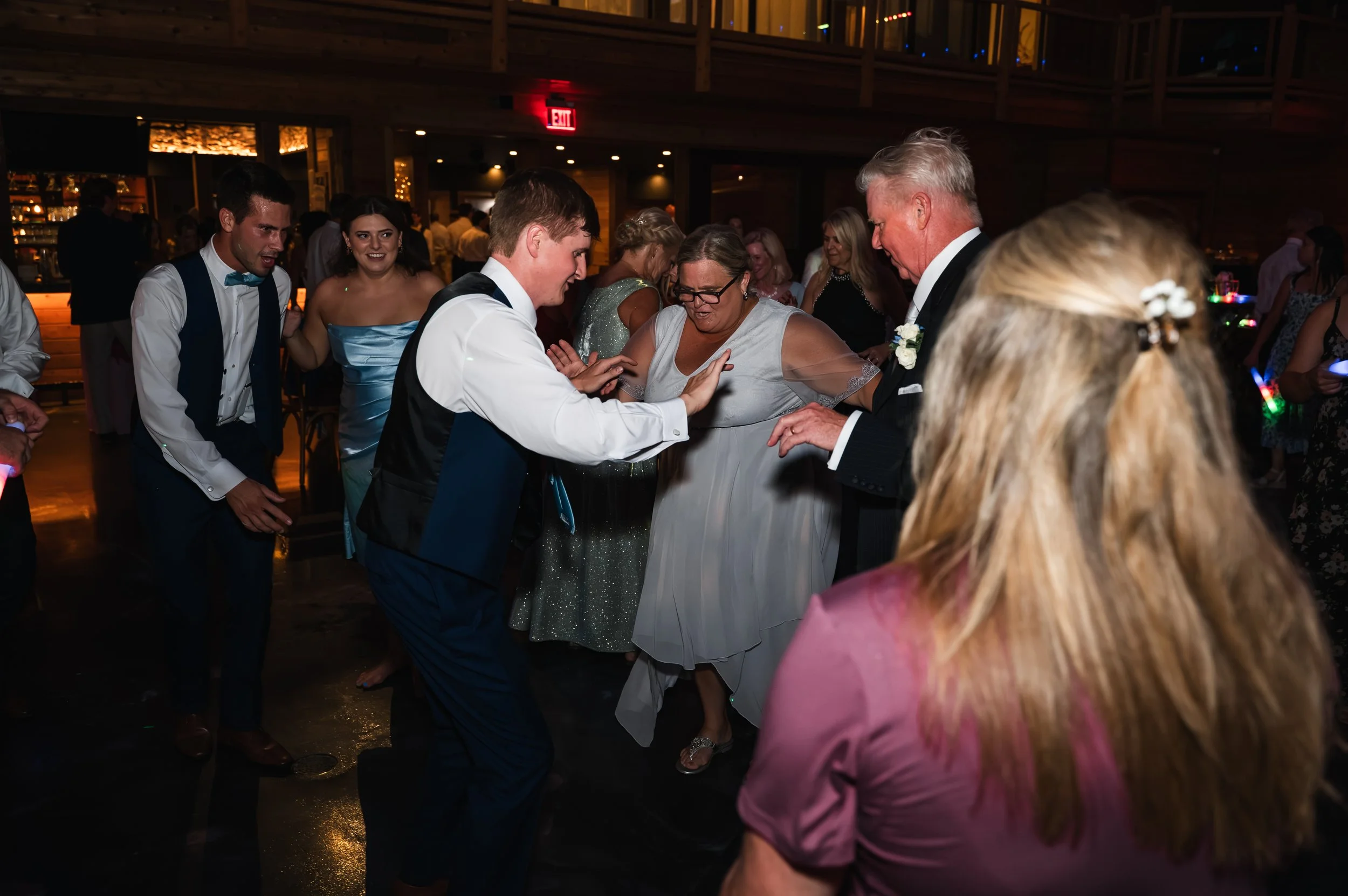Wedding guests of different generations dance together during Sydney and Matt’s reception at Gypsy Distillery.