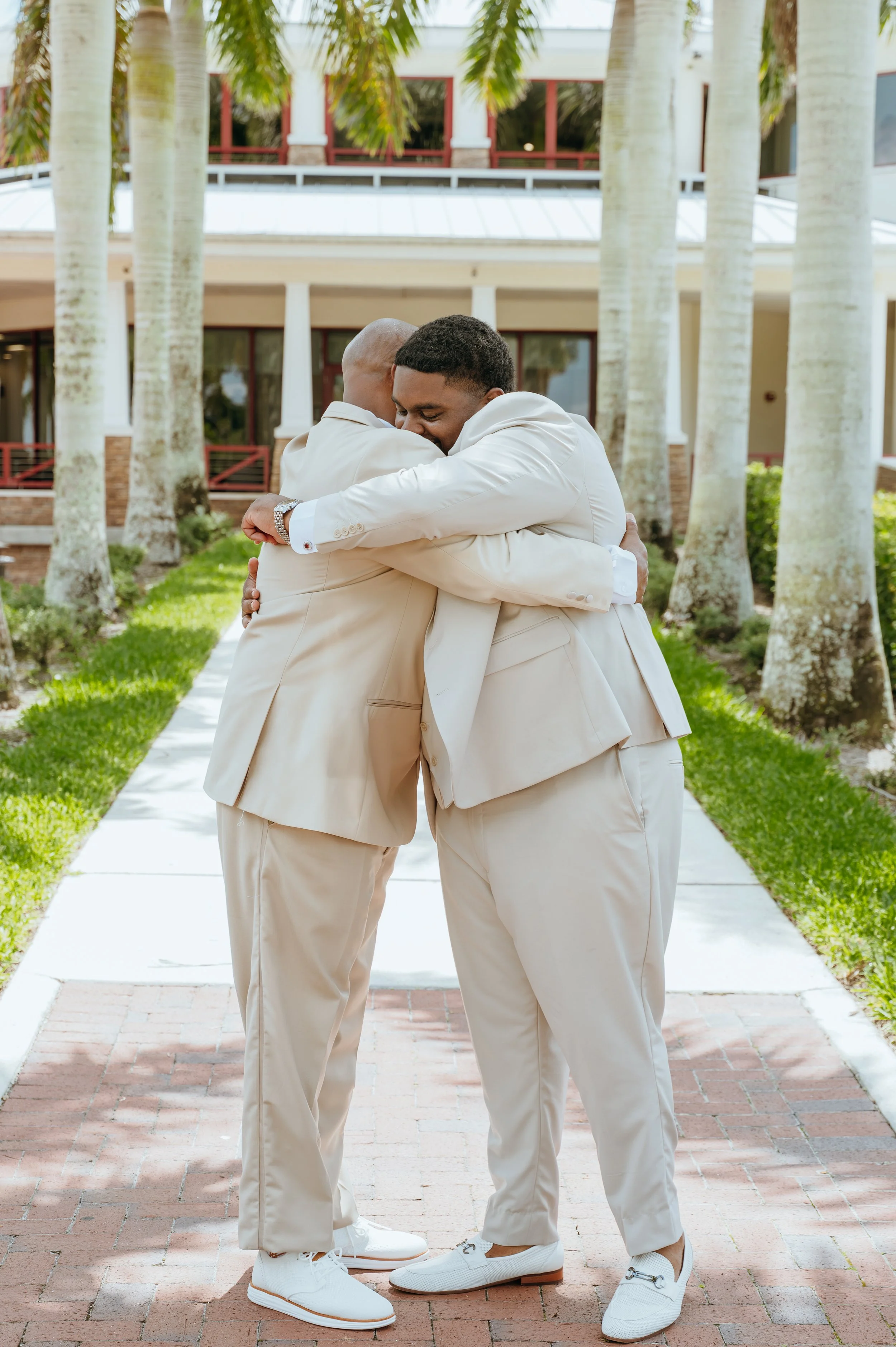 Groom Diego Waters sharing a heartfelt hug with a loved one following his Royal Palm Beach wedding ceremony.