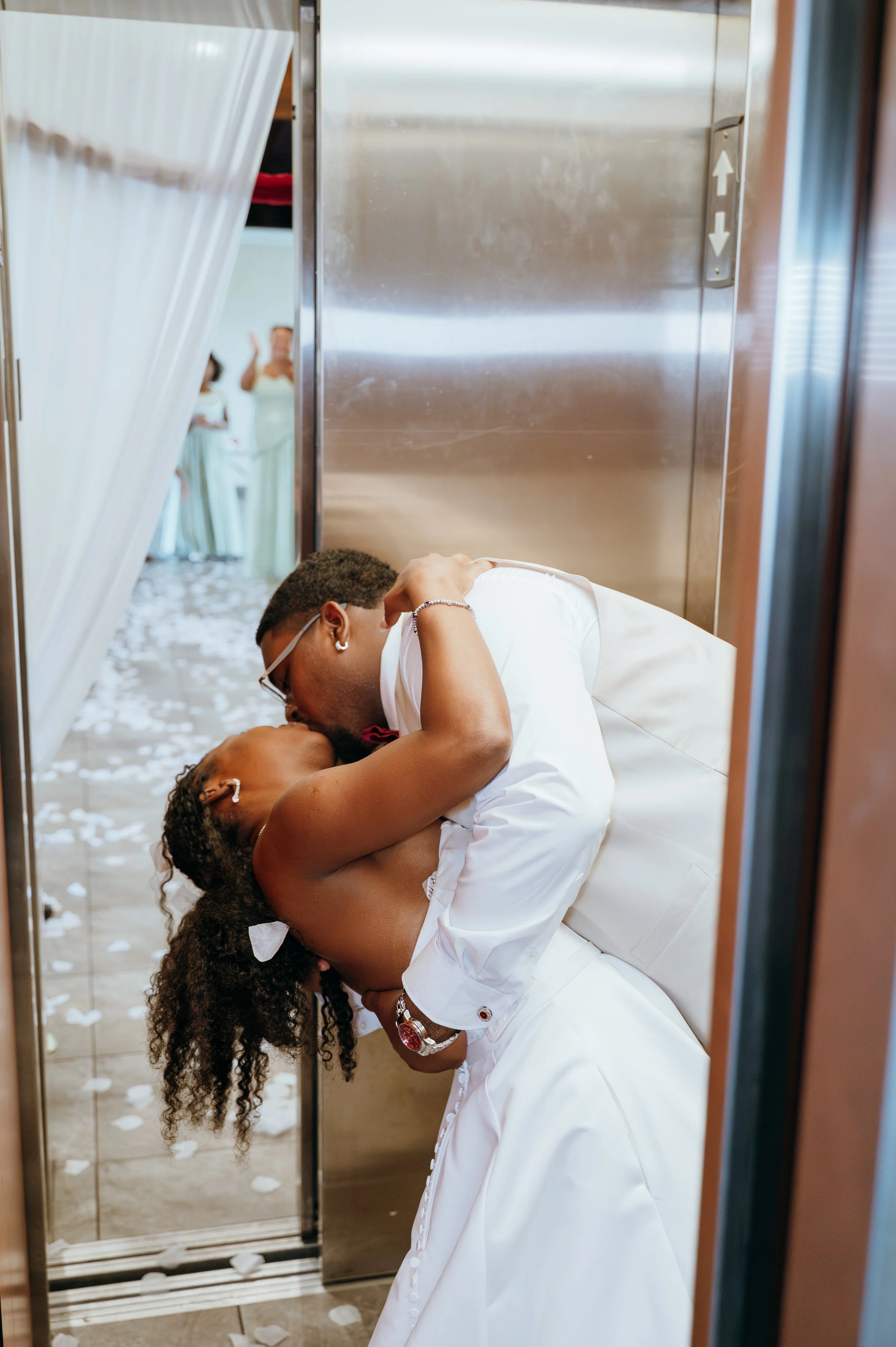 Anndi and Diego share a playful kiss in the elevator as they leave their wedding reception.