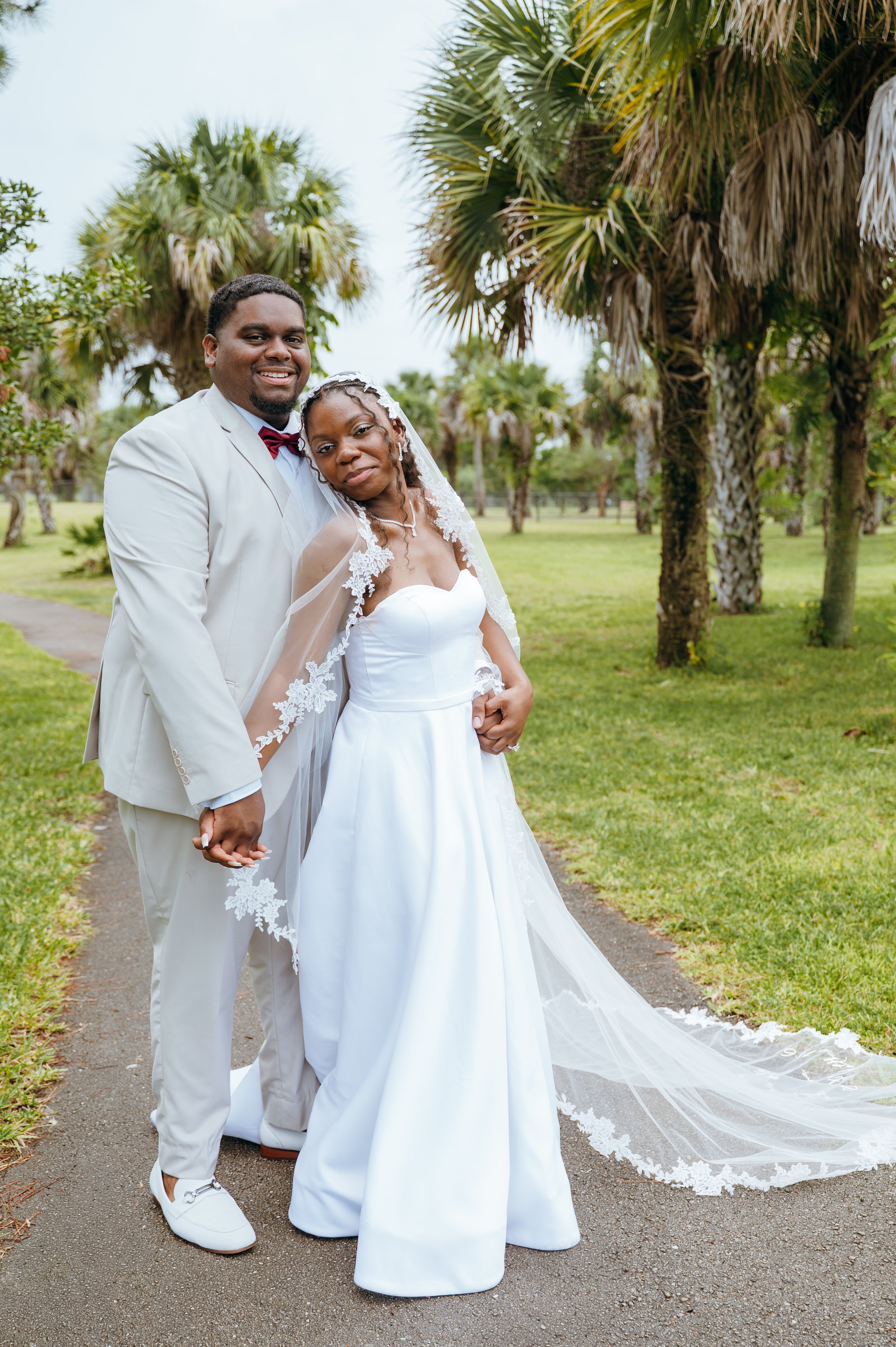 Anndi and Diego standing together in their wedding attire during their outdoor portraits.