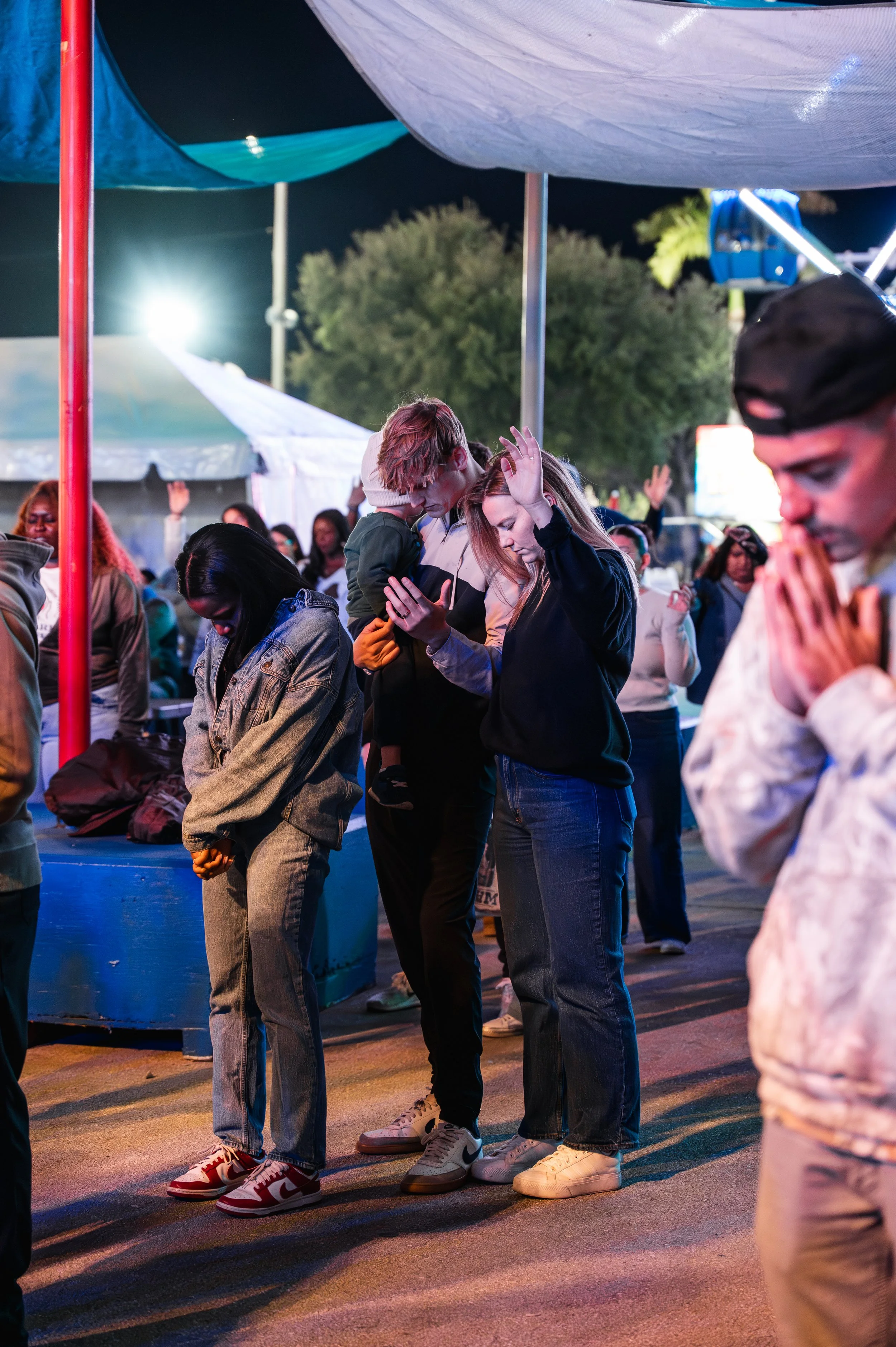 Attendees gathered in prayer during a Young in Faith event at the South Florida Fairgrounds.