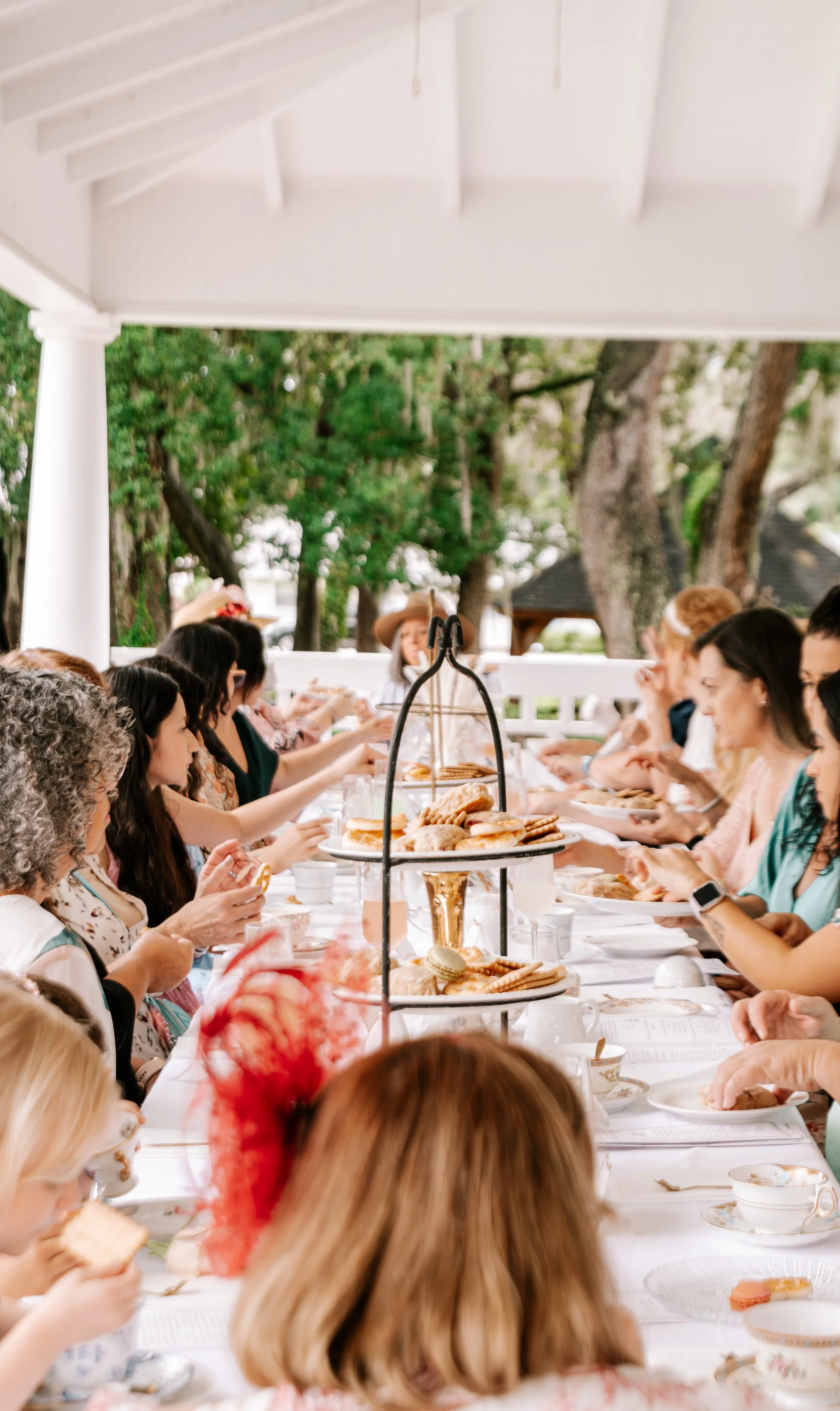 Guests enjoying afternoon tea together during a Bridgerton-inspired event in Lake County Florida.