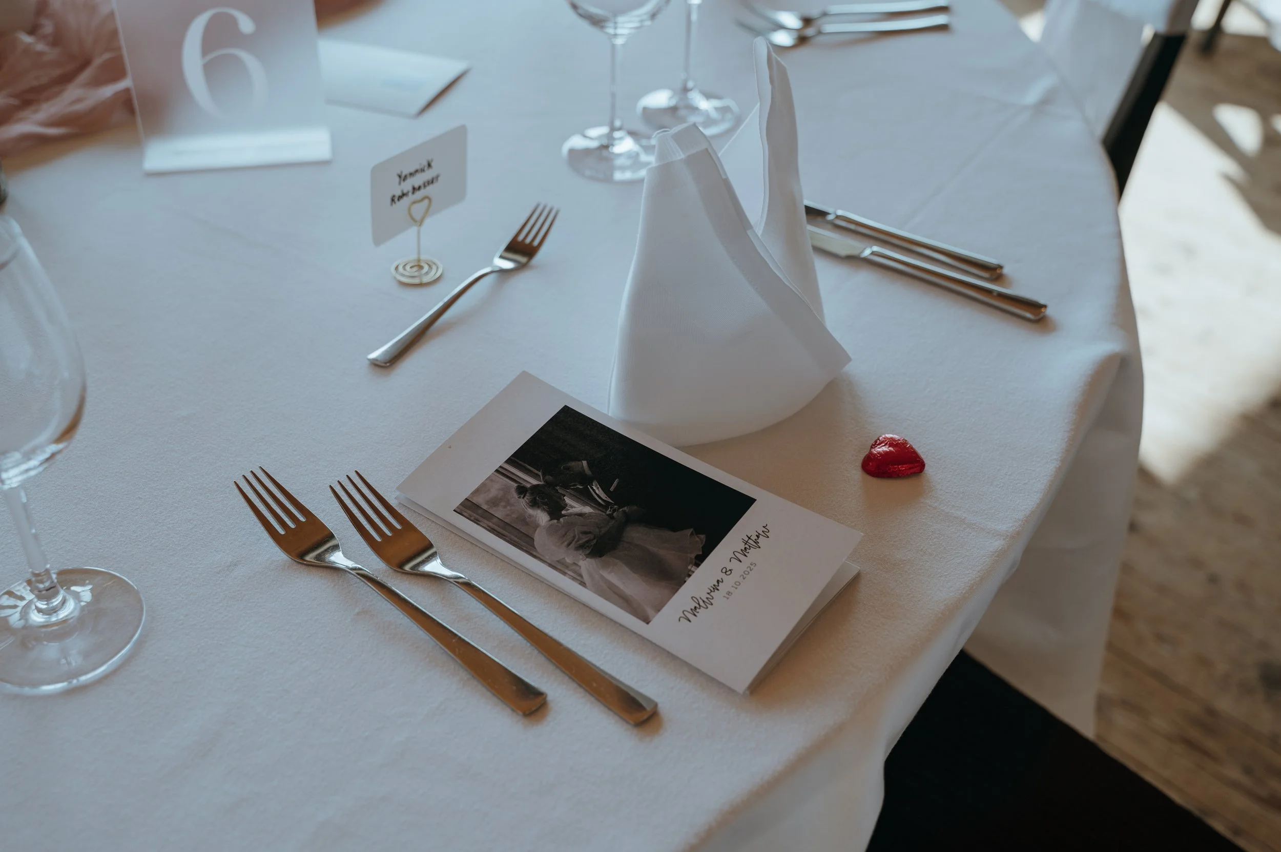 Wedding table details and a printed photograph prepared for guests at Jucker Farm in Switzerland