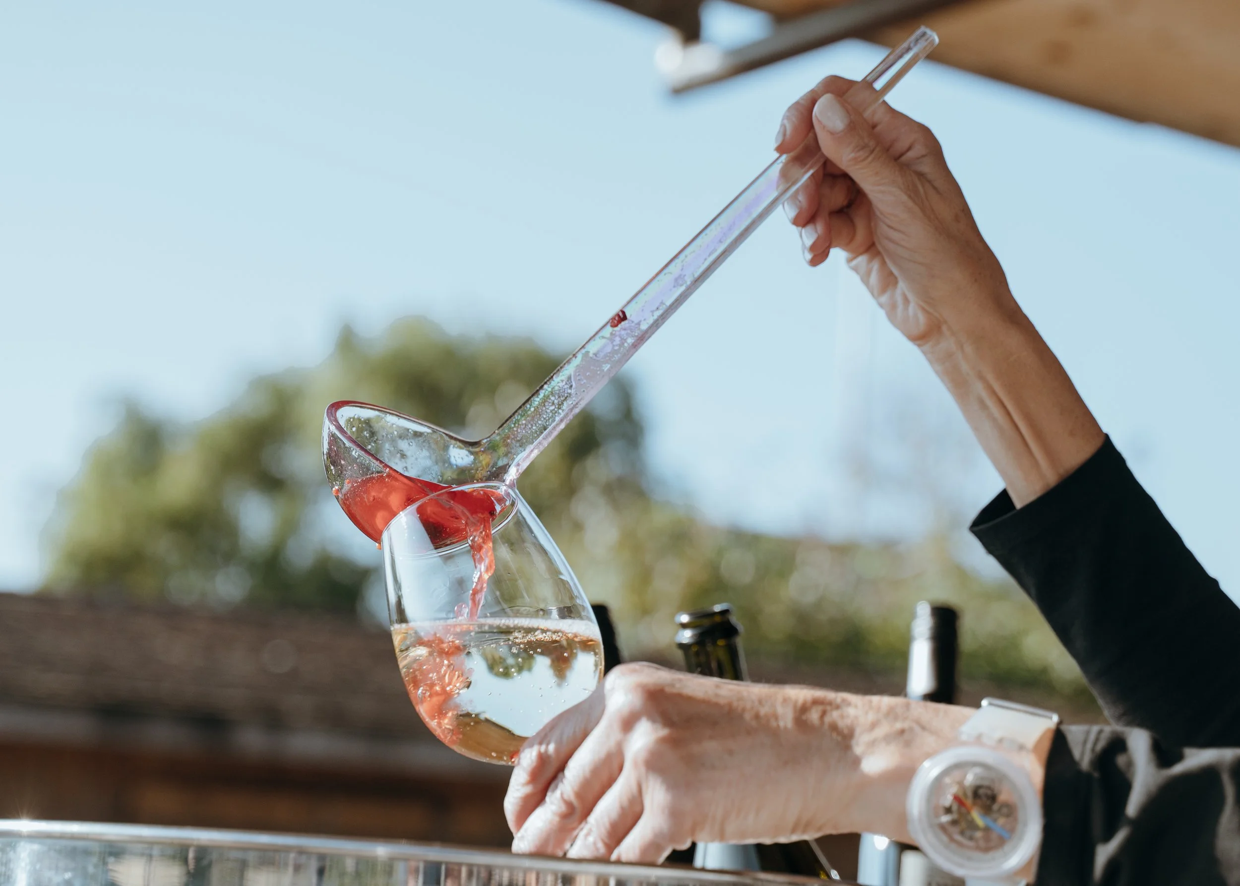 A colorful cocktail being poured during Malwina and Matthew’s outdoor wedding celebration in Switzerland