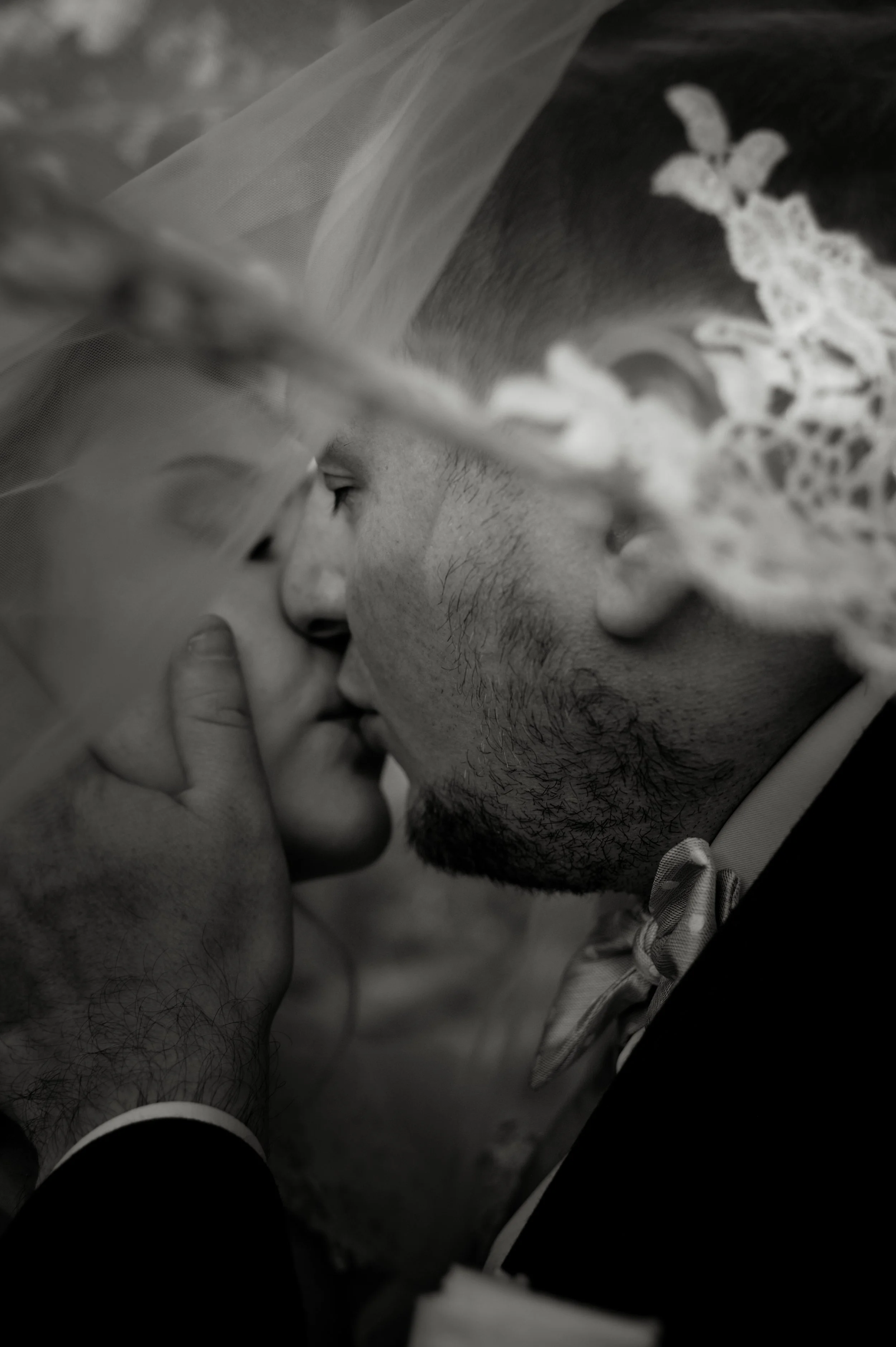 Black-and-white close-up of newlyweds kissing during their destination wedding in Switzerland