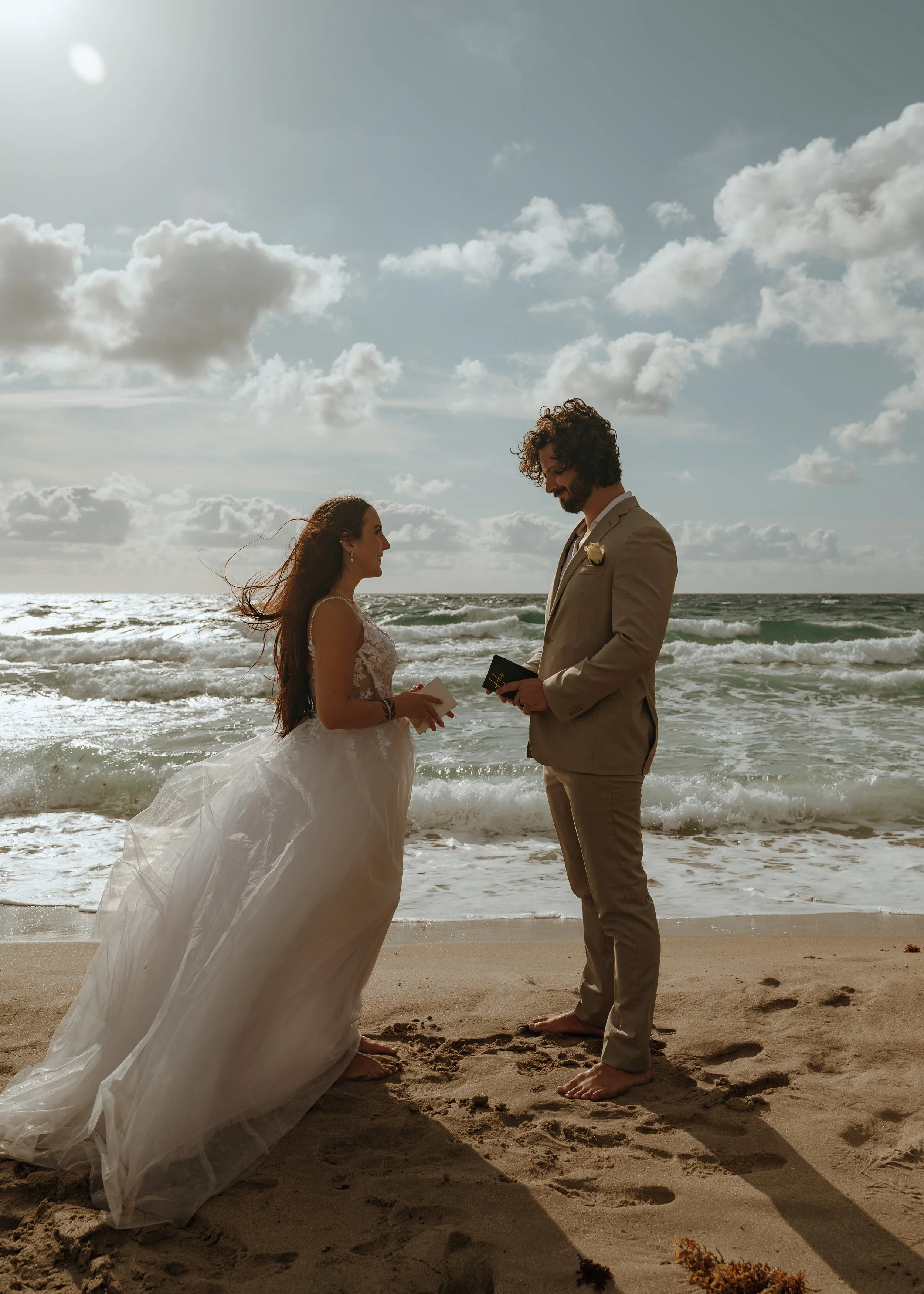Couple stands with their officiant during an intimate beach elopement at Atlantic Dunes in Delray Beach, Florida.