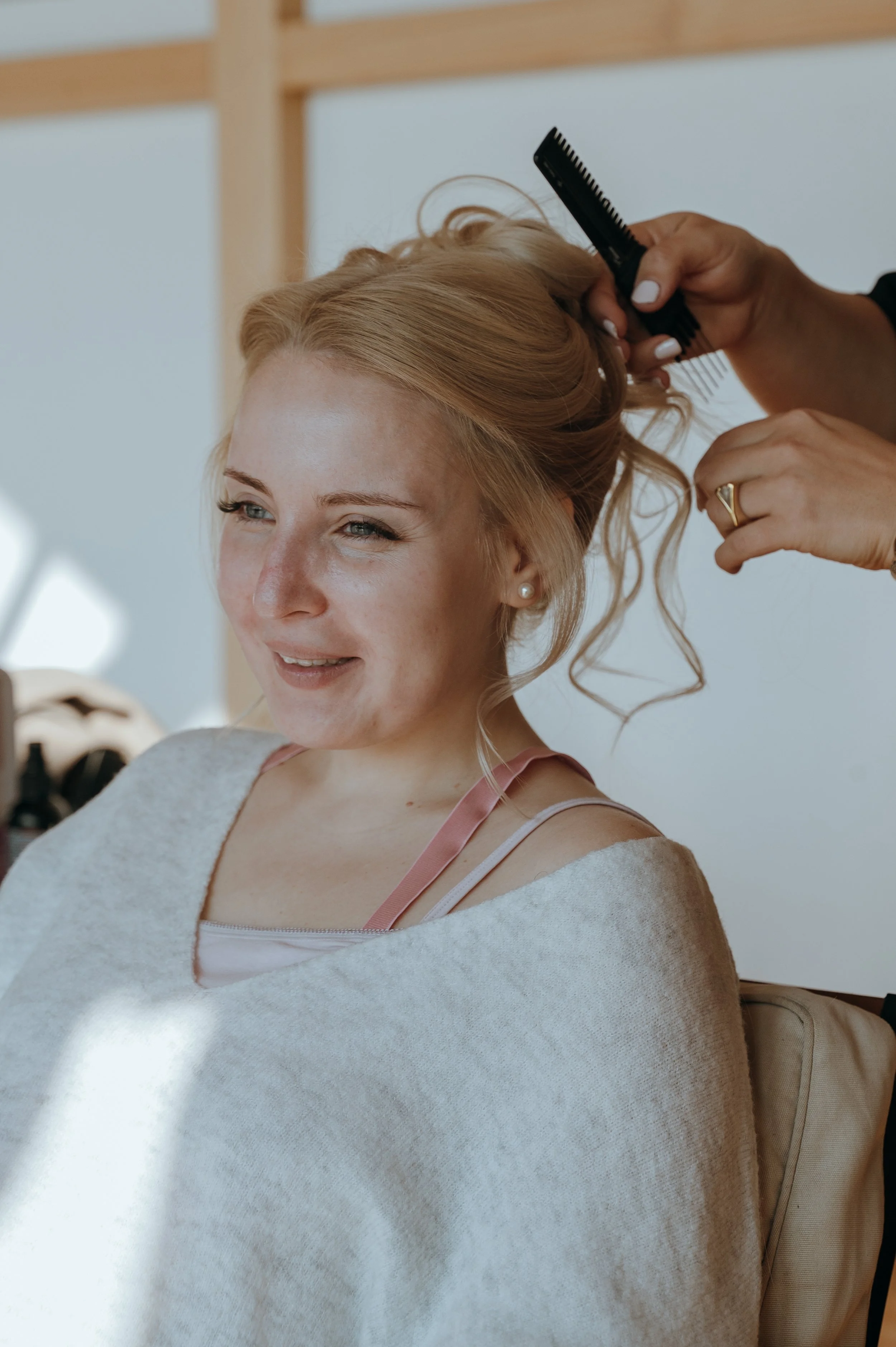 Bride having her hair styled before her destination wedding in Rapperswil-Jona, Switzerland