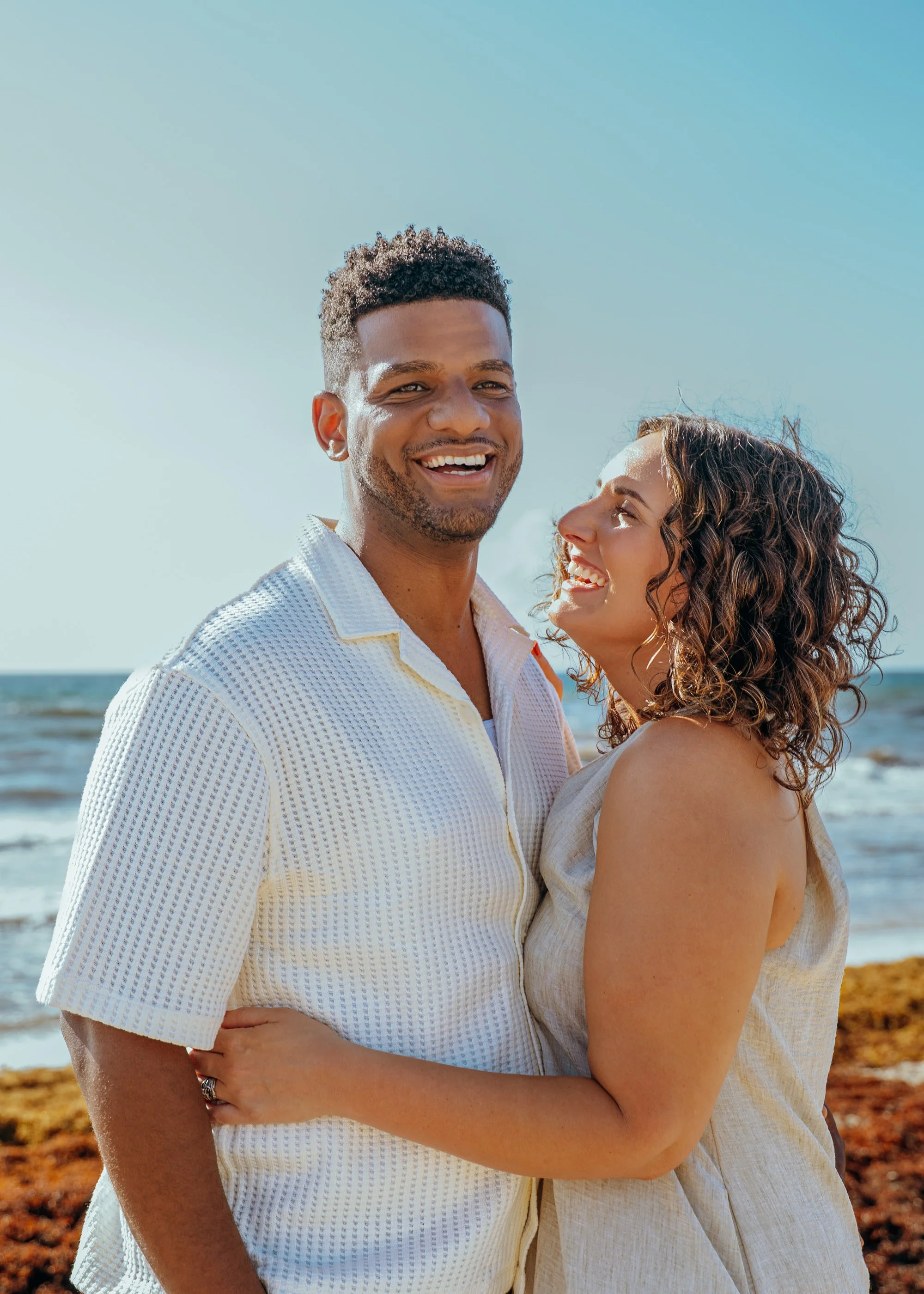 Couple laughing together during a South Florida beach session.