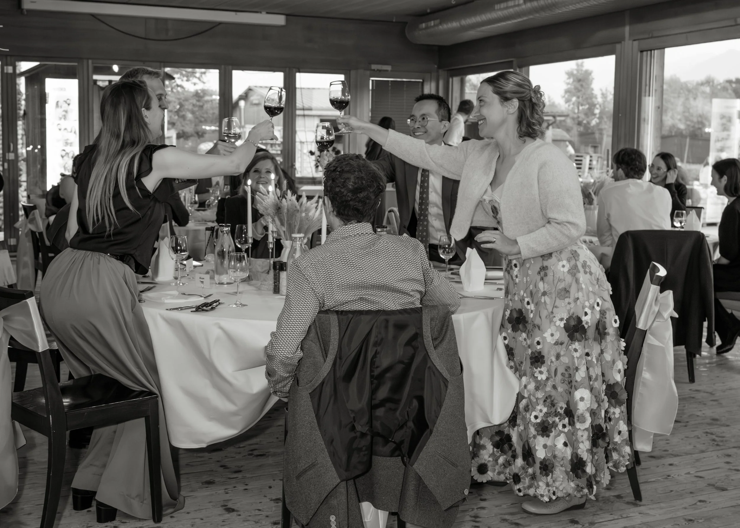 Wedding guests raising their glasses during Malwina and Matthew’s reception in Switzerland