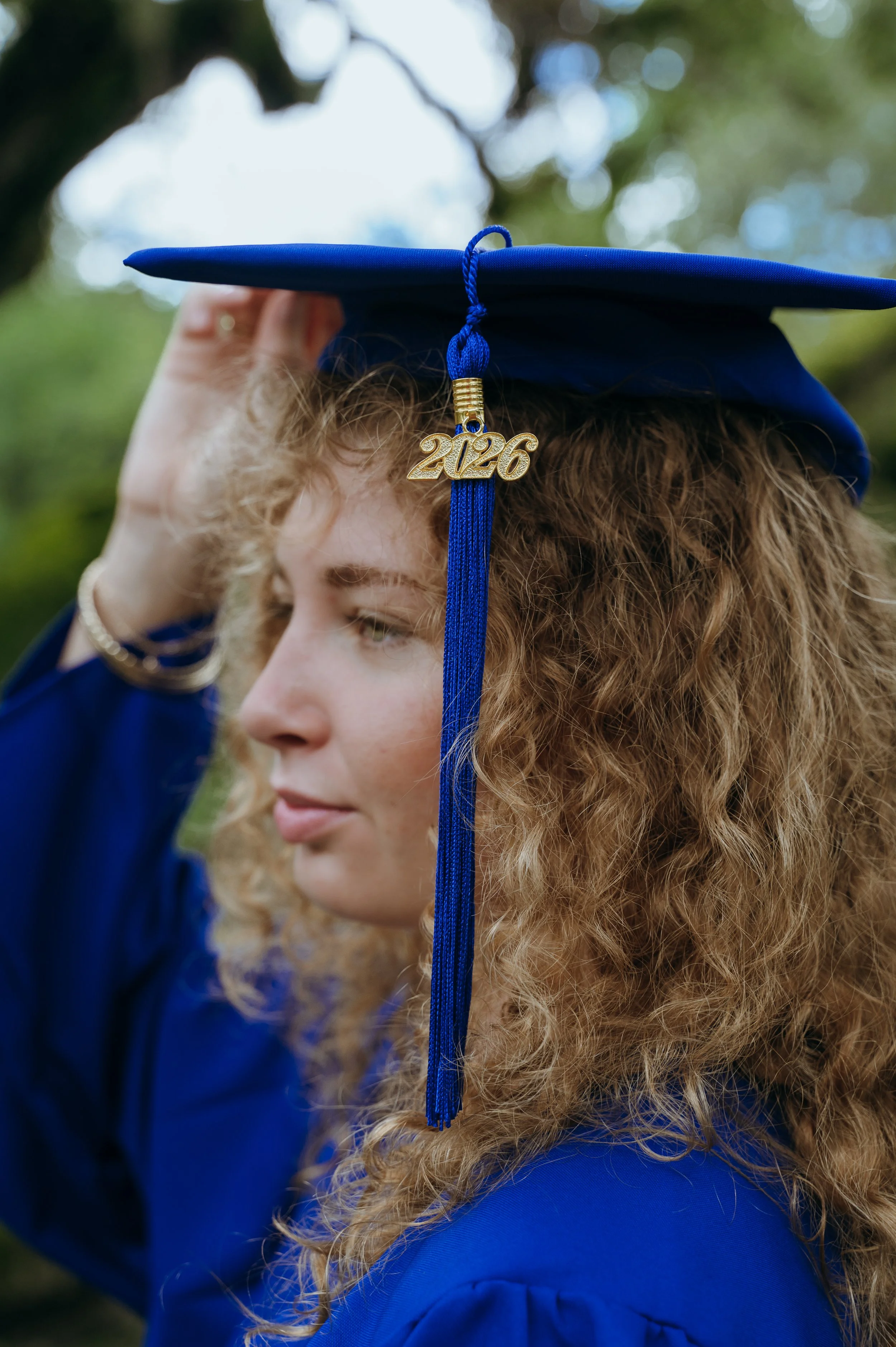 Close-up of a high school senior wearing a blue 2026 graduation cap at Vizcaya Museum and Gardens in Miami, Florida.