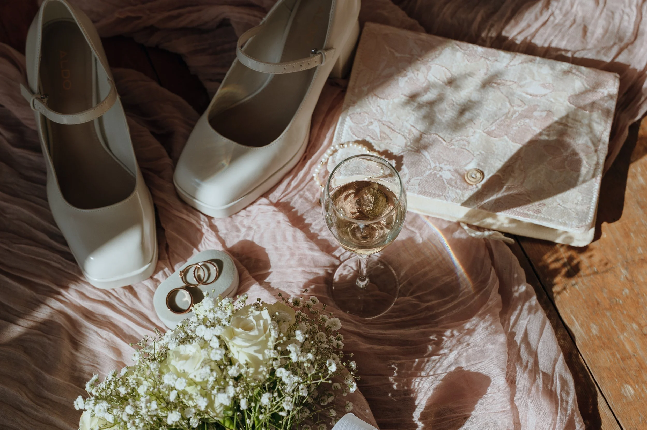 Bridal shoes, wedding rings, bouquet, and wedding-day details arranged before a destination wedding in Switzerland
