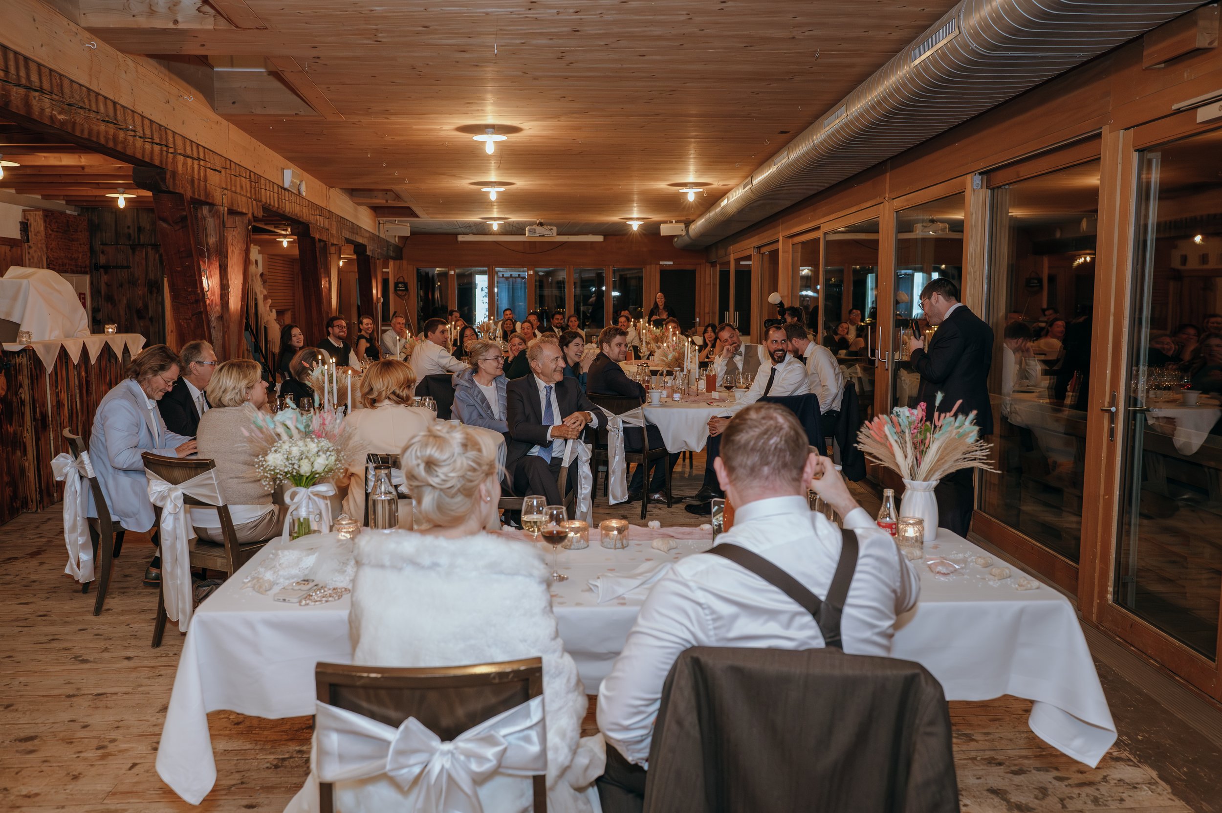 Guests gathered for Malwina and Matthew’s wedding reception inside Jucker Farm in Switzerland.