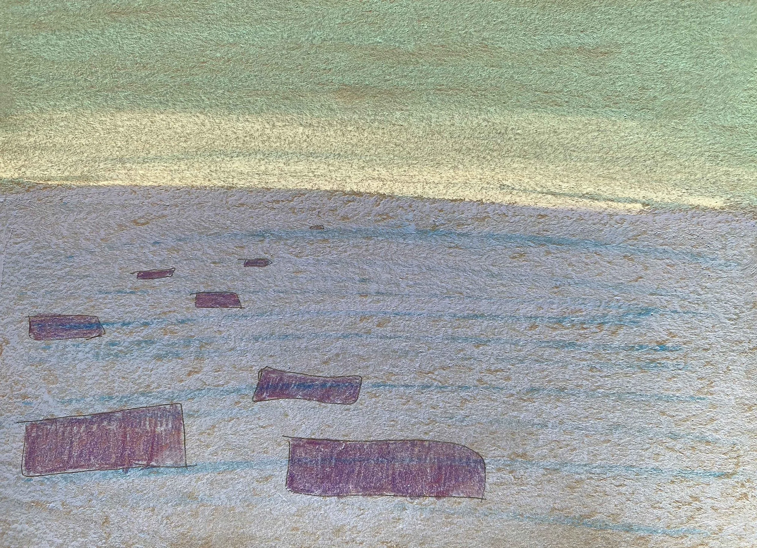 A photograph of rectangular objects scattered on a sandy beach with a calm sea and sky in the background, taken during sunset or sunrise.