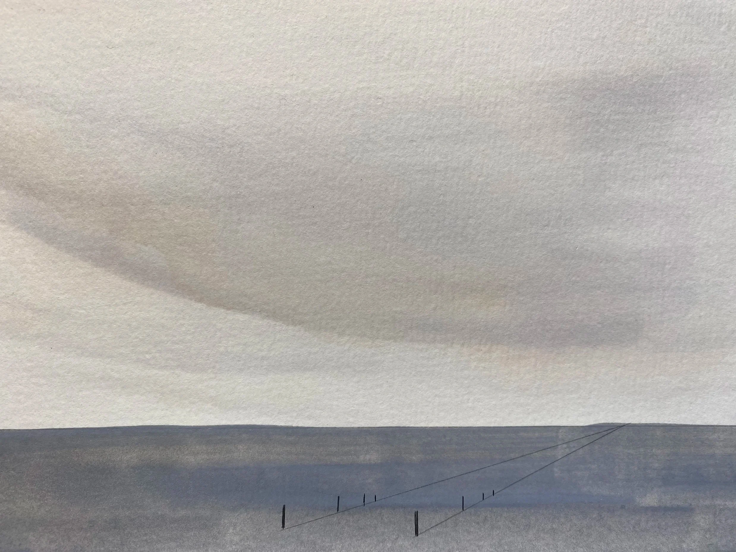 A snow-covered landscape with power lines stretching into the distance under a cloudy sky.