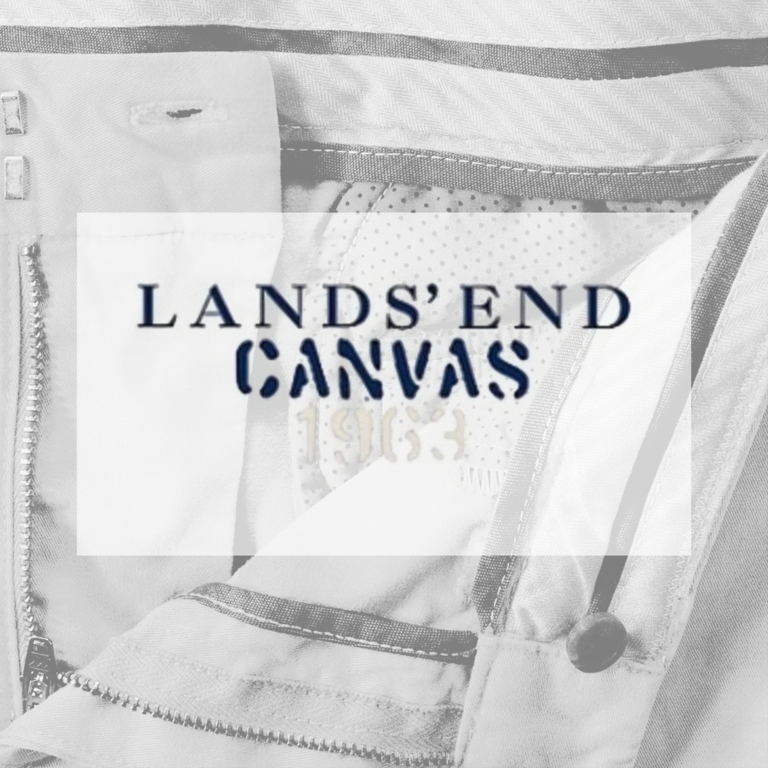 Close-up of a fabric item with a label reading 'LANDS' END CANVAS 1963', with visible zipper and button details.