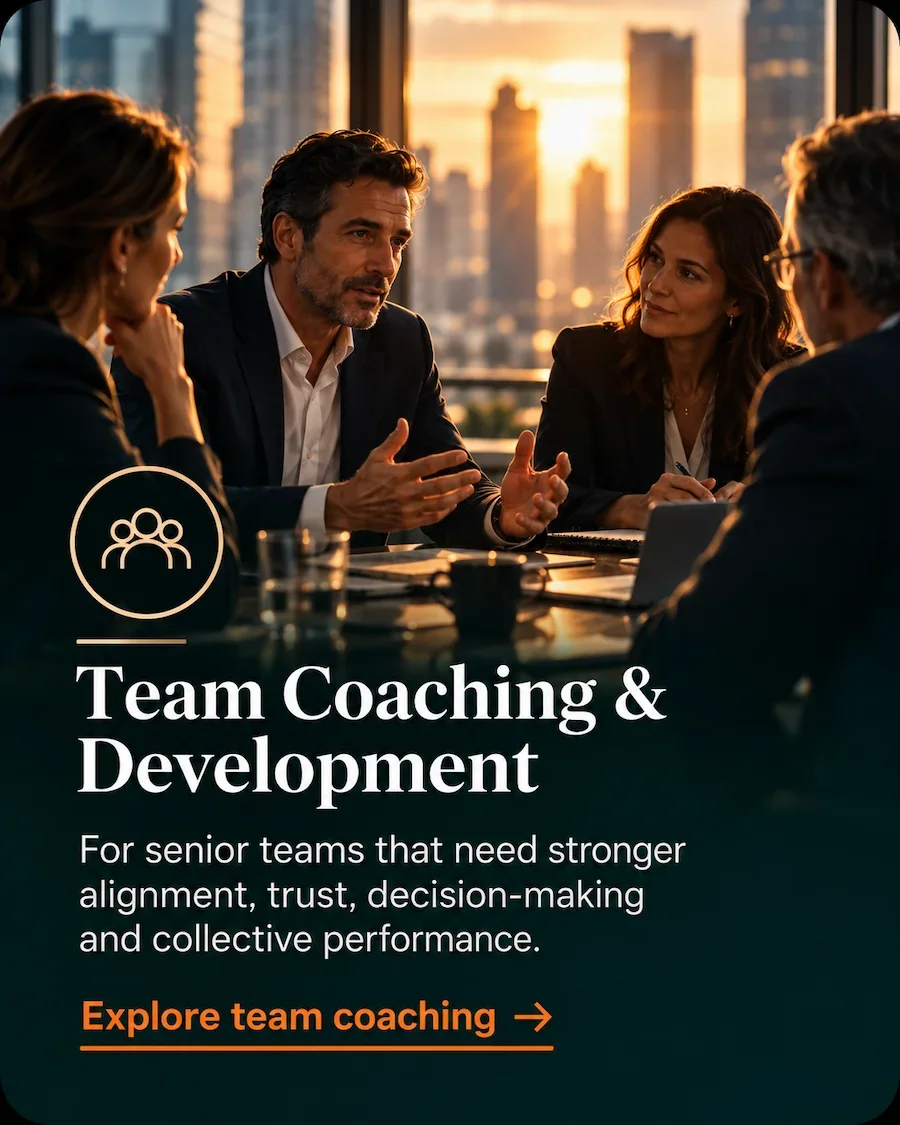 Senior leadership team in discussion, representing team coaching and leadership development.