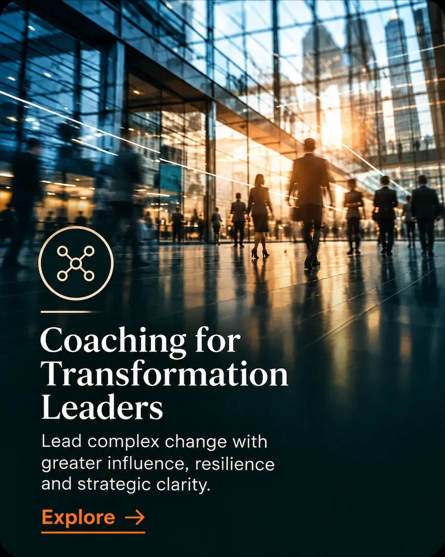 Senior leaders moving through a modern corporate environment, representing transformation leadership coaching.