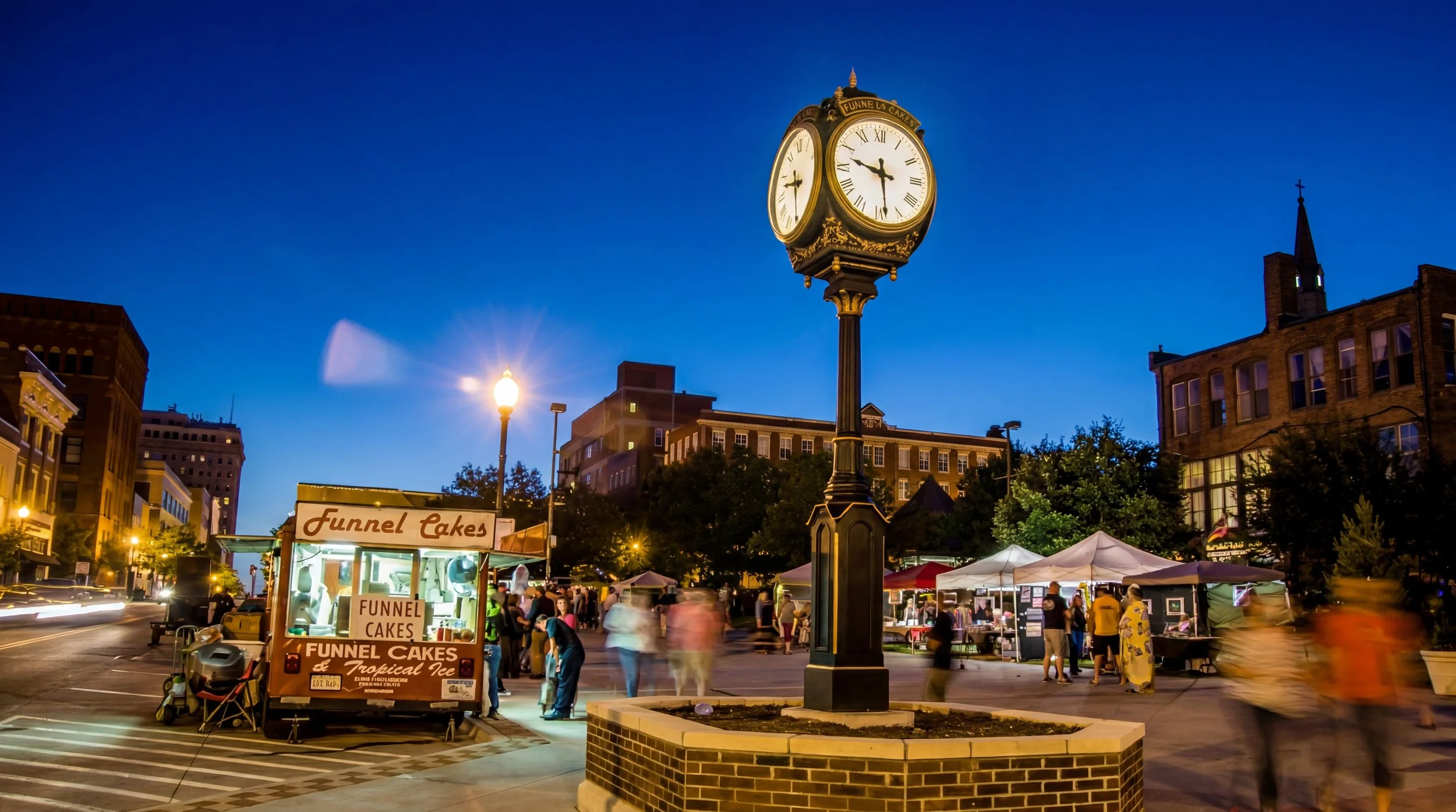 Downtown St. Joseph Missouri street market with historic clock tower at night