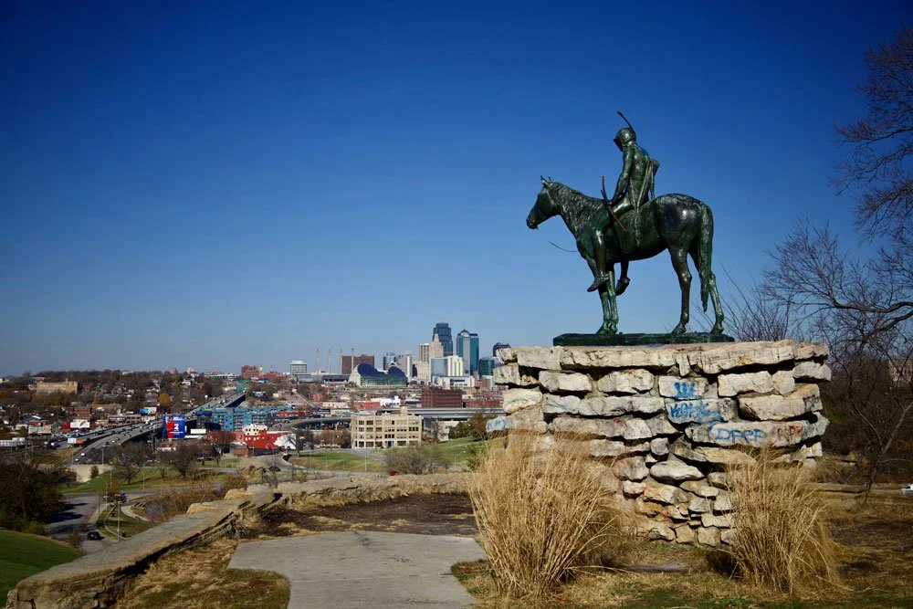 The Scout statue overlooking Kansas City, offering a panoramic view of the city skyline and surrounding landscape.