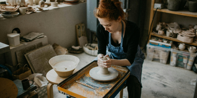 Woman throwing pottery
