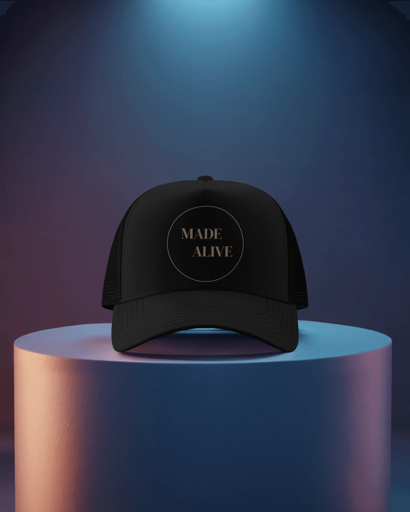 trucker-cap-mockup-front-view-on-pedestal-under-spotlight-with-gradient-studio-background-0367 (1).png
