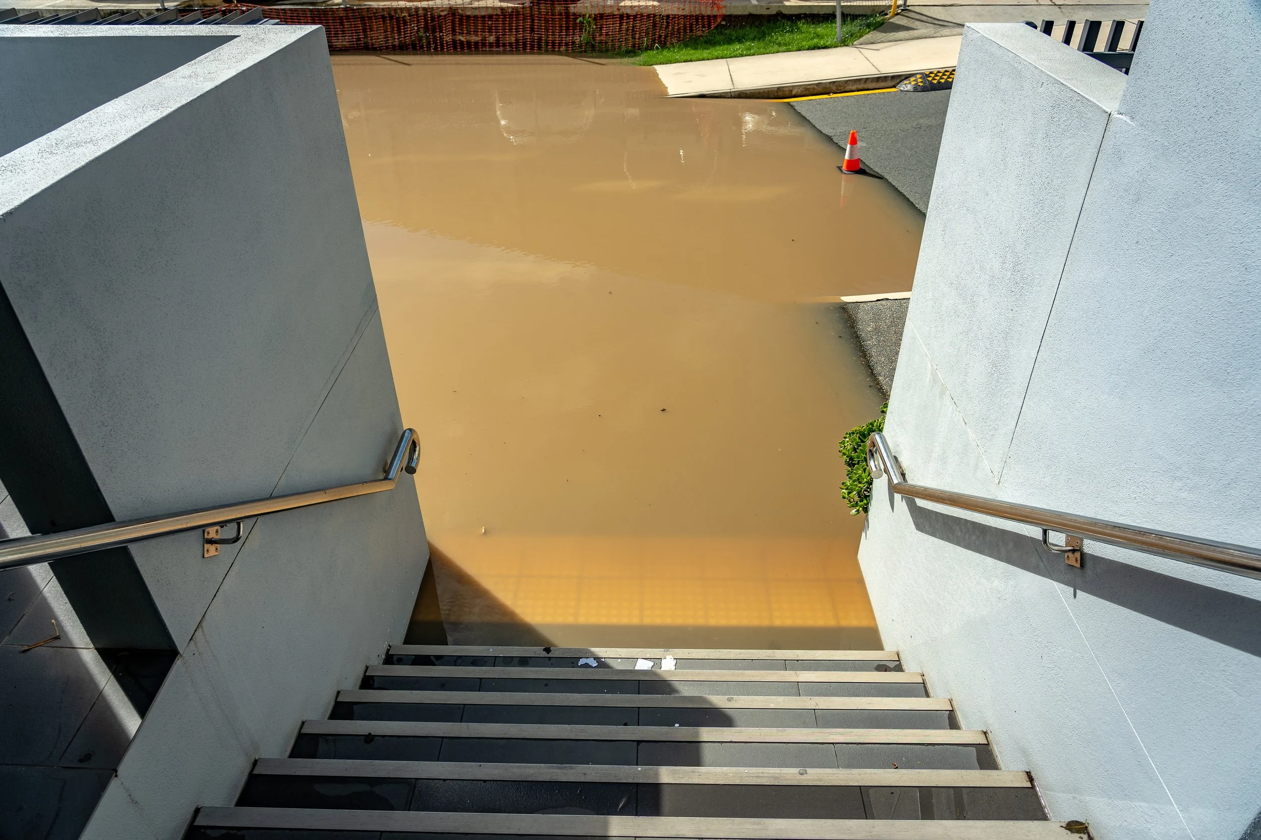 View from top of staircase leading into flooded street.