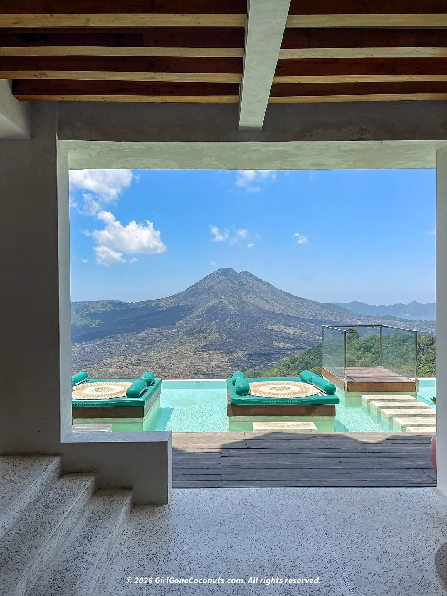 Infinity pool daybeds at Paperhills cafe overlooking Mount Batur volcano, Kintamani Bali.
