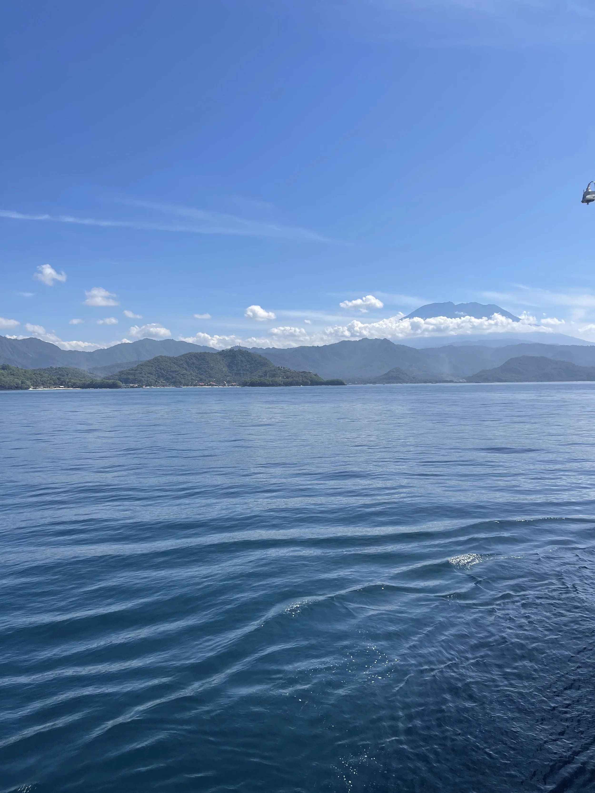 View of Lombok mountains and coastline from the public ferry crossing from Bali.