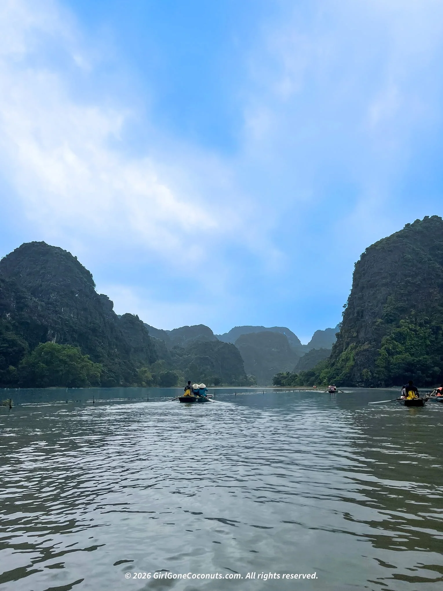 Boat ride along the Tam Coc river through limestone karsts, Ninh Binh Vietnam.