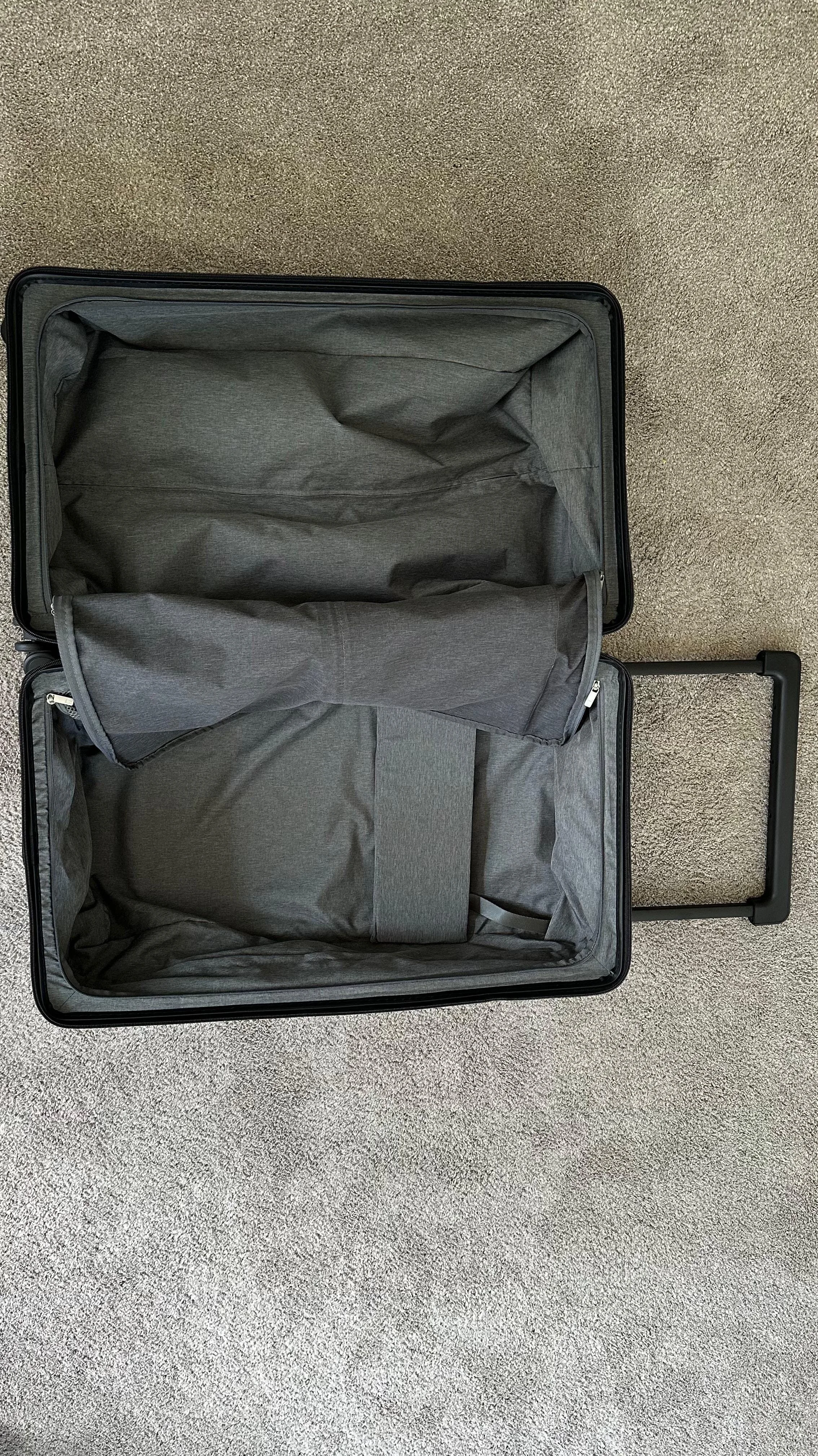 The inside area of the suitcase, unzipped and ready to be packed.