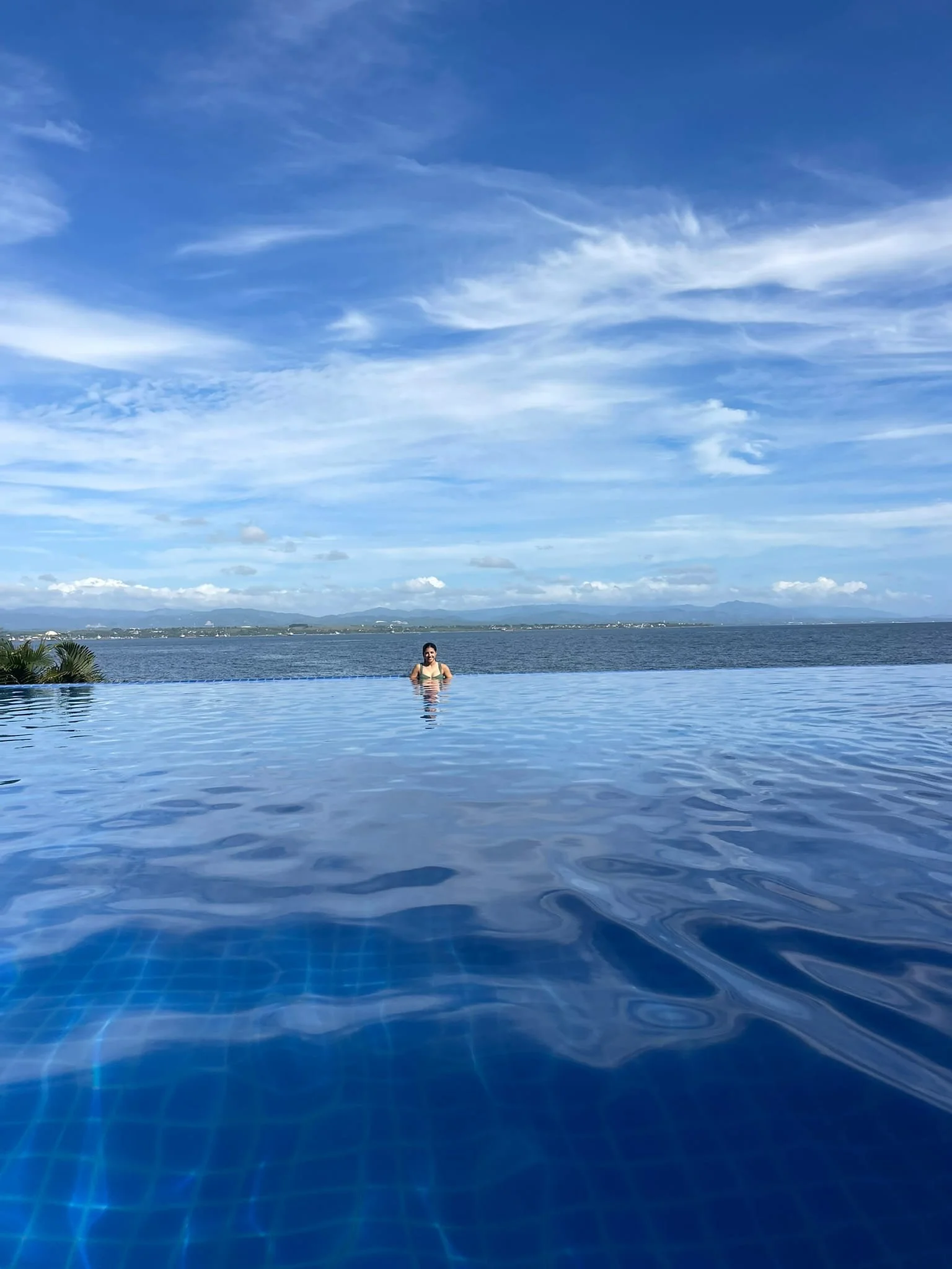 Traveler swimming in the infinity pool.