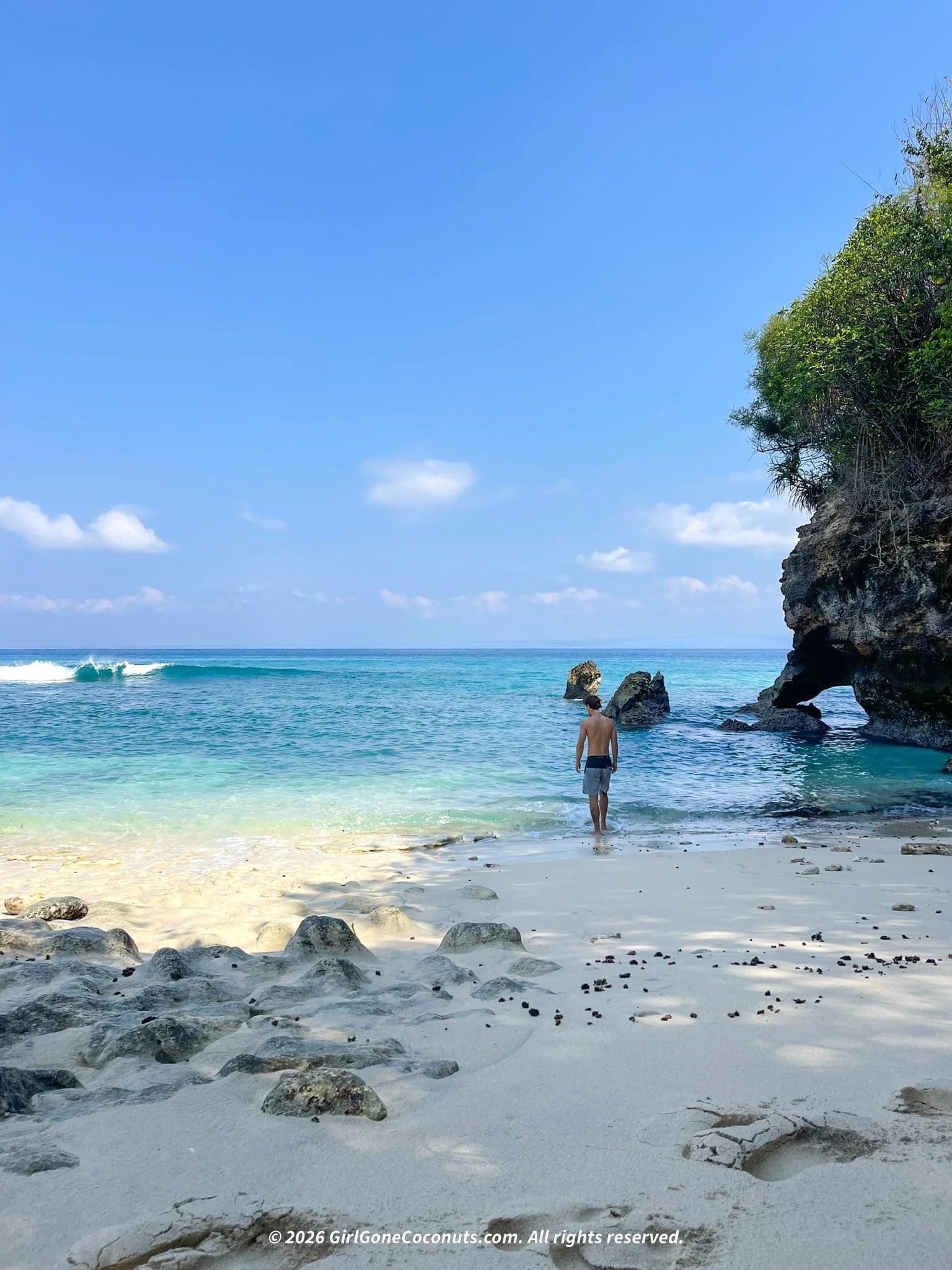Traveler wandering in the turquoise blue waters at Hidden Beach in Nusa Lembongan.