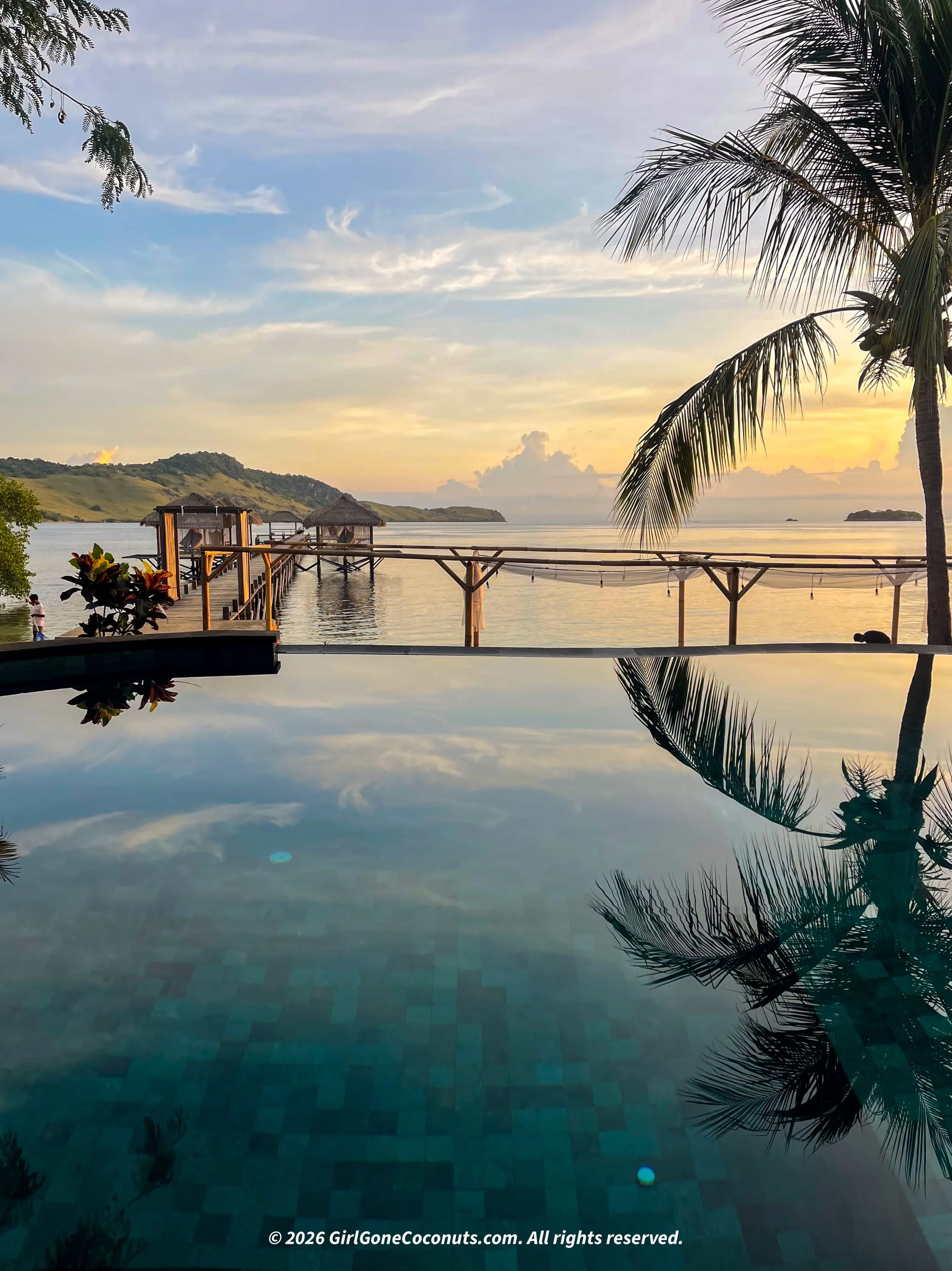 The pool and jetty during sunrise at The Seraya Resort in Komodo, Flores.
