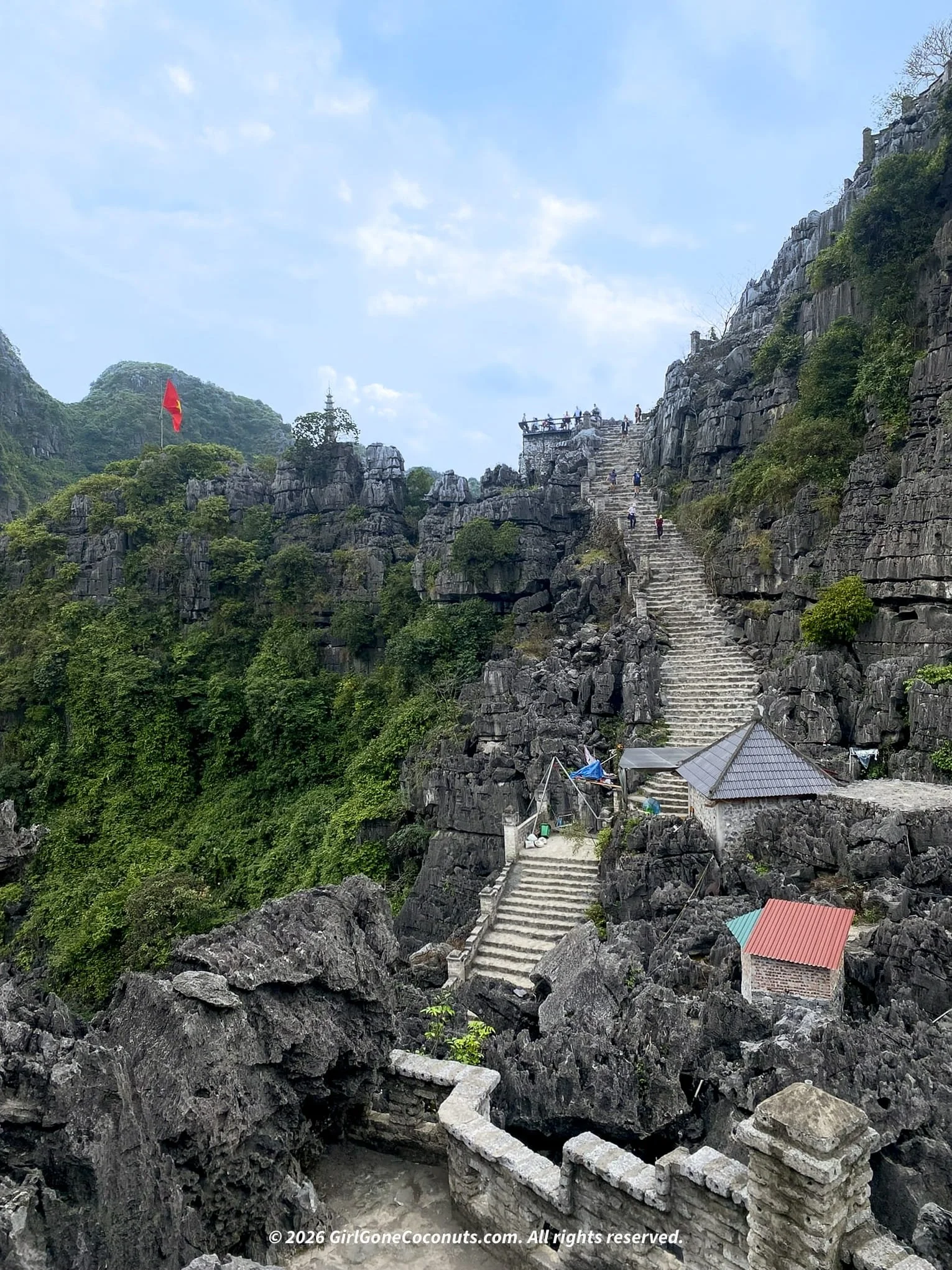 Stone steps leading up to Hang Mua Viewpoint with limestone karsts in the background, Ninh Binh Vietnam.