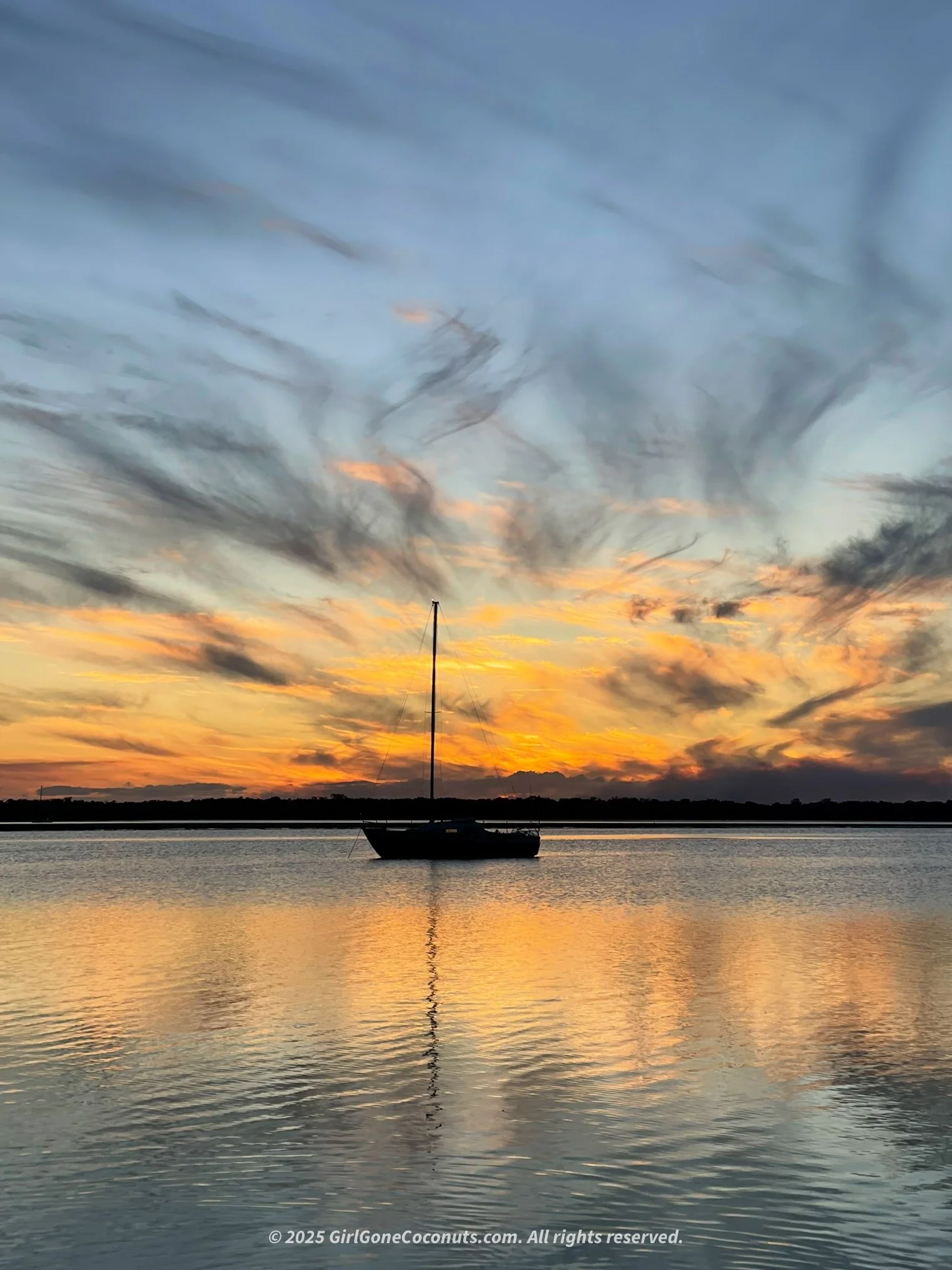 Watching an unforgettable Rainbow Beach sunset over the water.