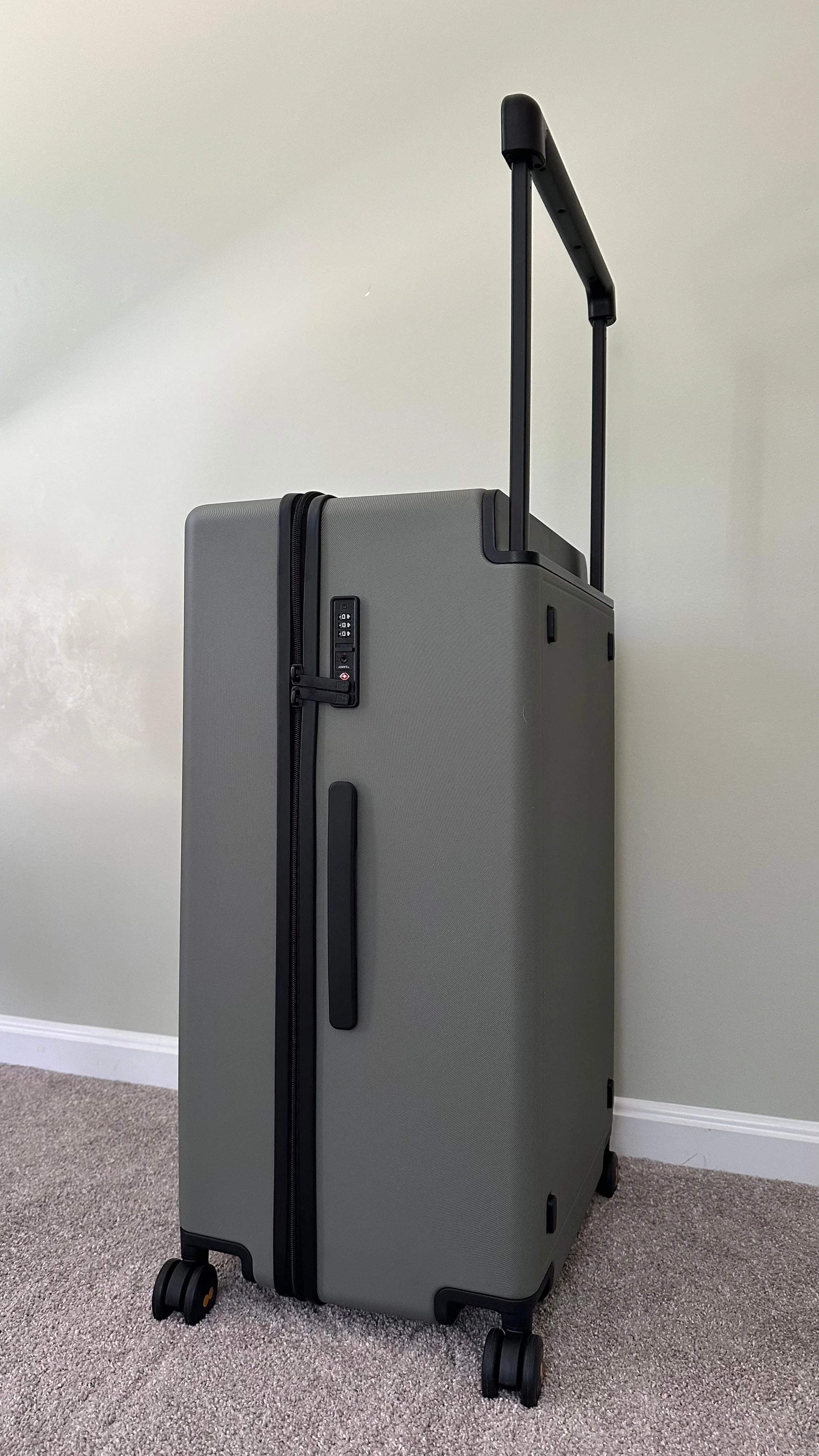 A side view of the suitcase with the TSA lock.