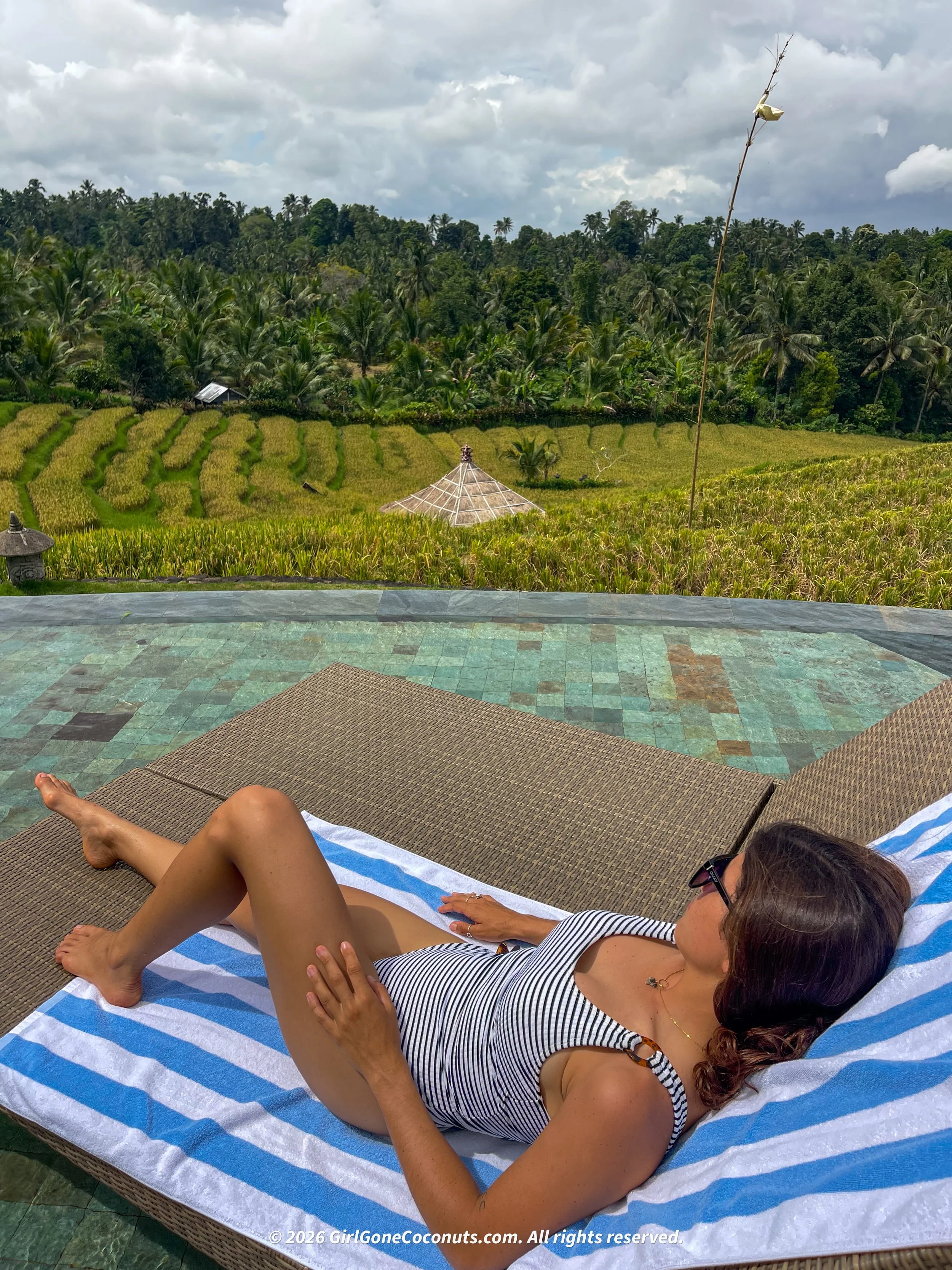 Sunbathing and relaxing at the pool at Puri Dajuma in Bali.