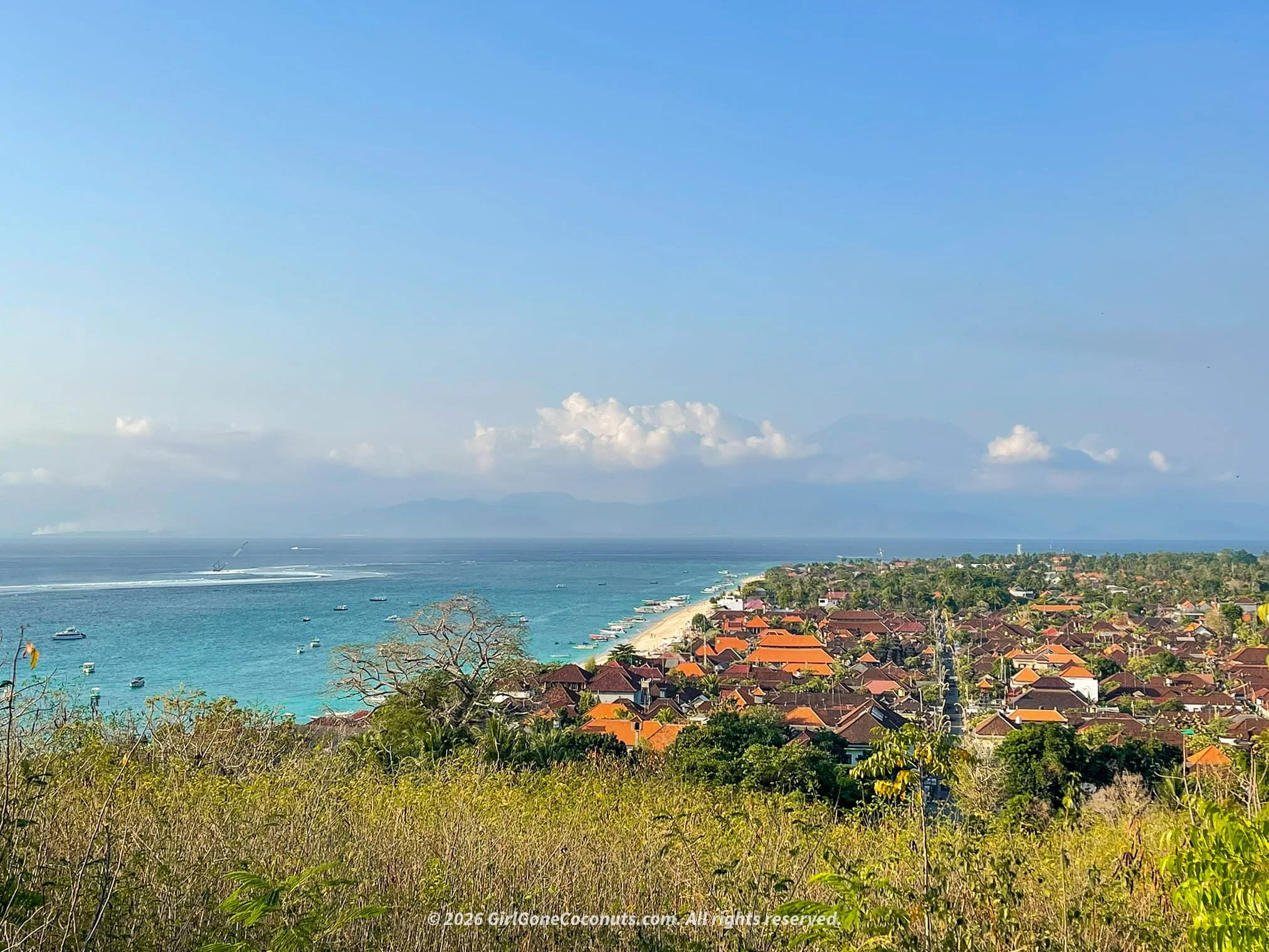 180 degree view over Nusa Lembongan Island, with Mount Agung in the background and the island's dreamy blue waters.