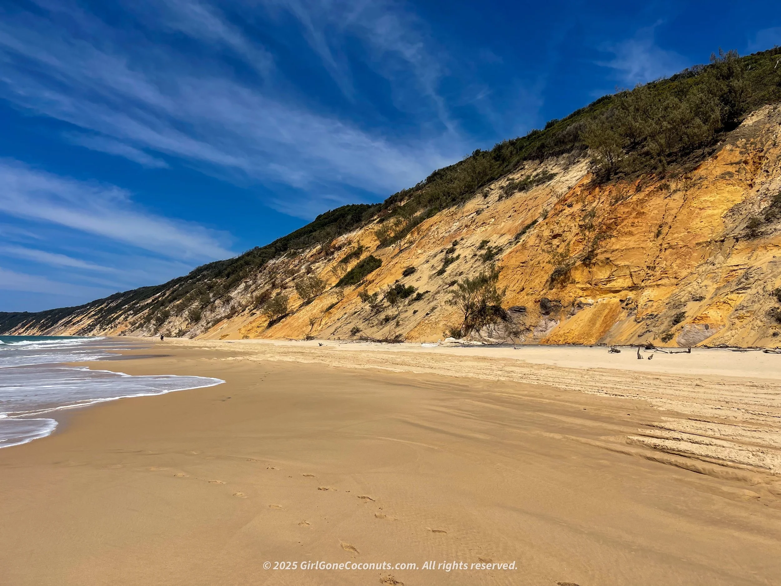 The coloured sands in Rainbow Beach are an iconic spot to explore.