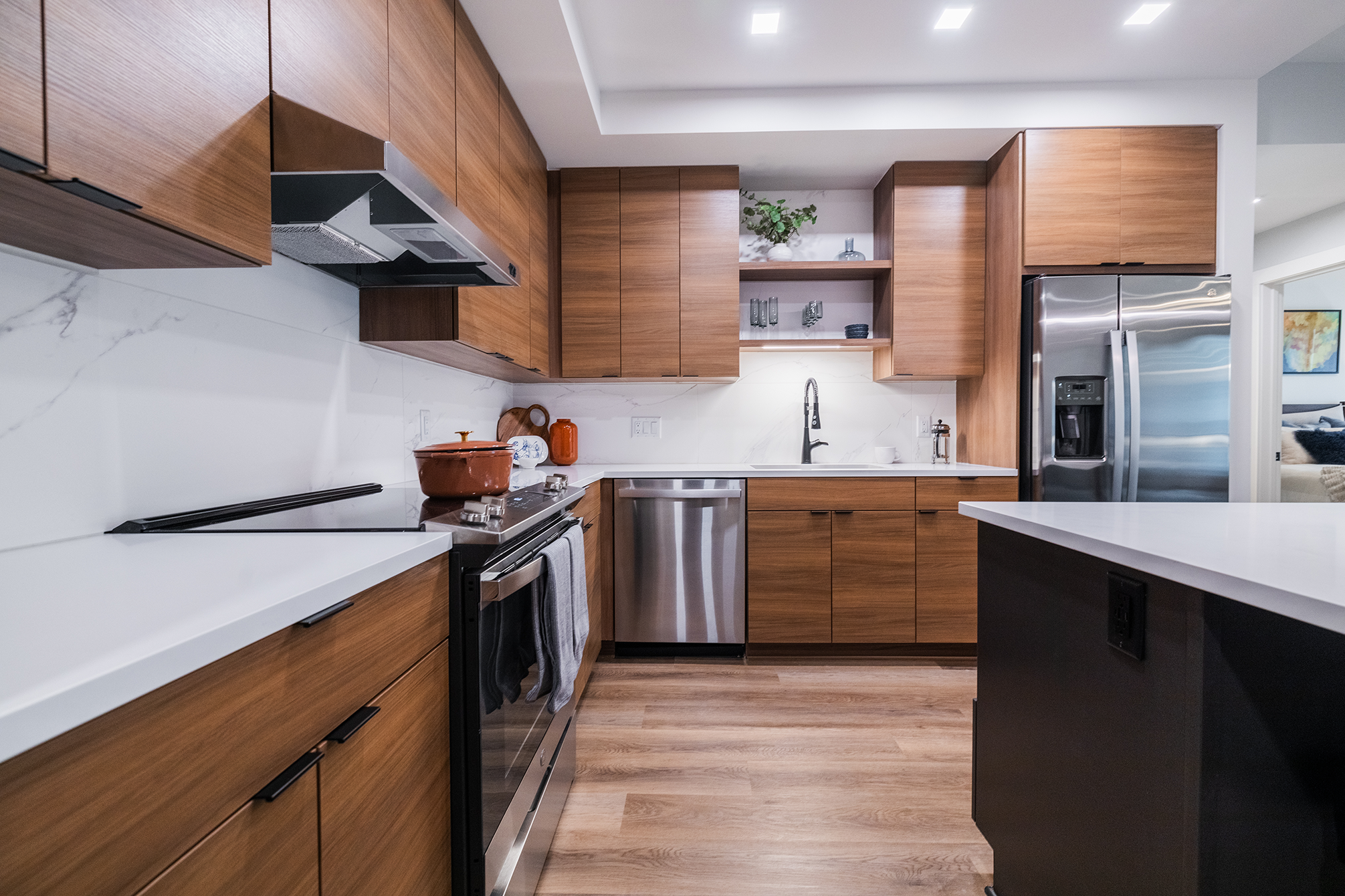Finished modern kitchen renovation with warm wood cabinetry and a functional layout, showing how updating an existing home creates long-term comfort, efficiency, and everyday ease.