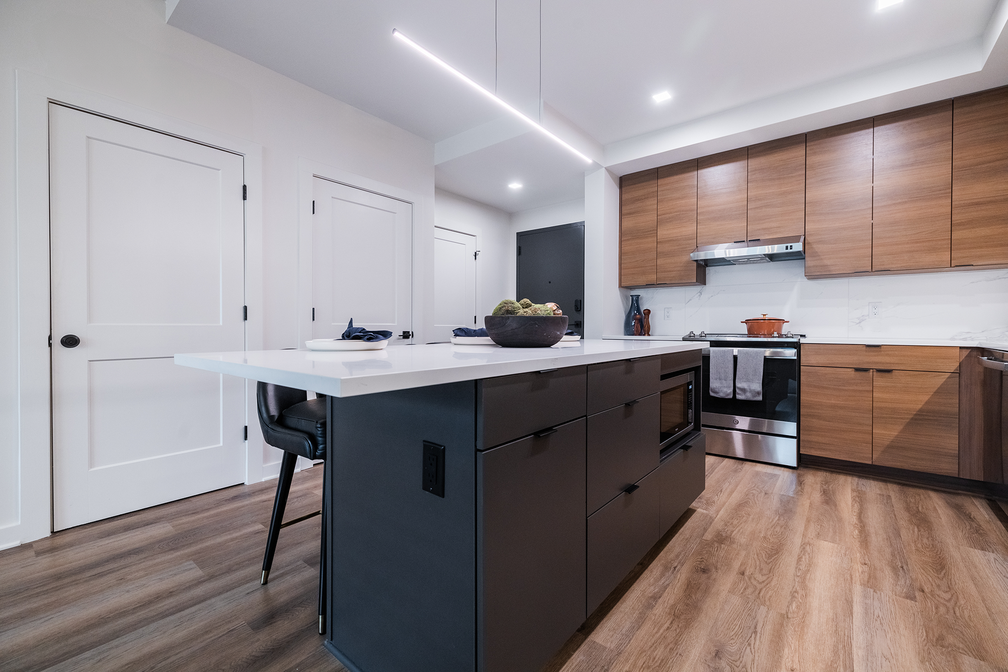 Modern kitchen renovation with a functional island, integrated storage, and clean-lined cabinetry, demonstrating how thoughtful design updates improve daily flow and usability in an existing home.