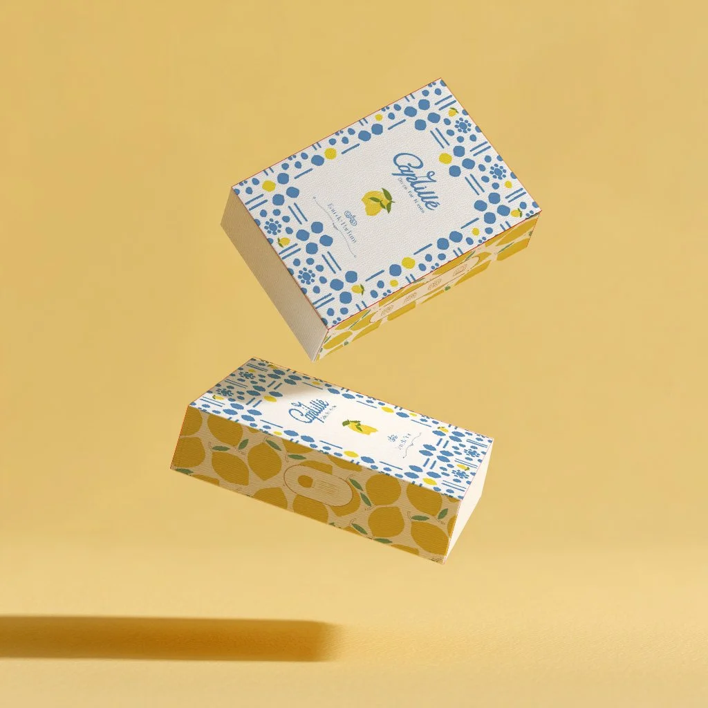Two boxes of citrus fruit-themed product with blue and yellow packaging design, floating against a yellow background.
