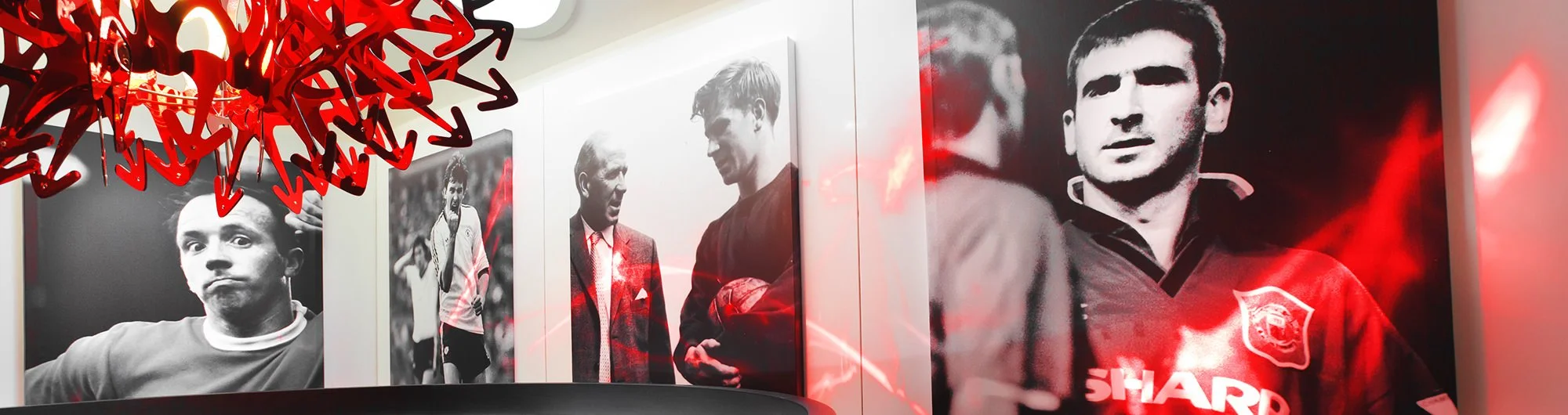 Players lounge Old Trafford, Manchester United with historic players displayed on the walls