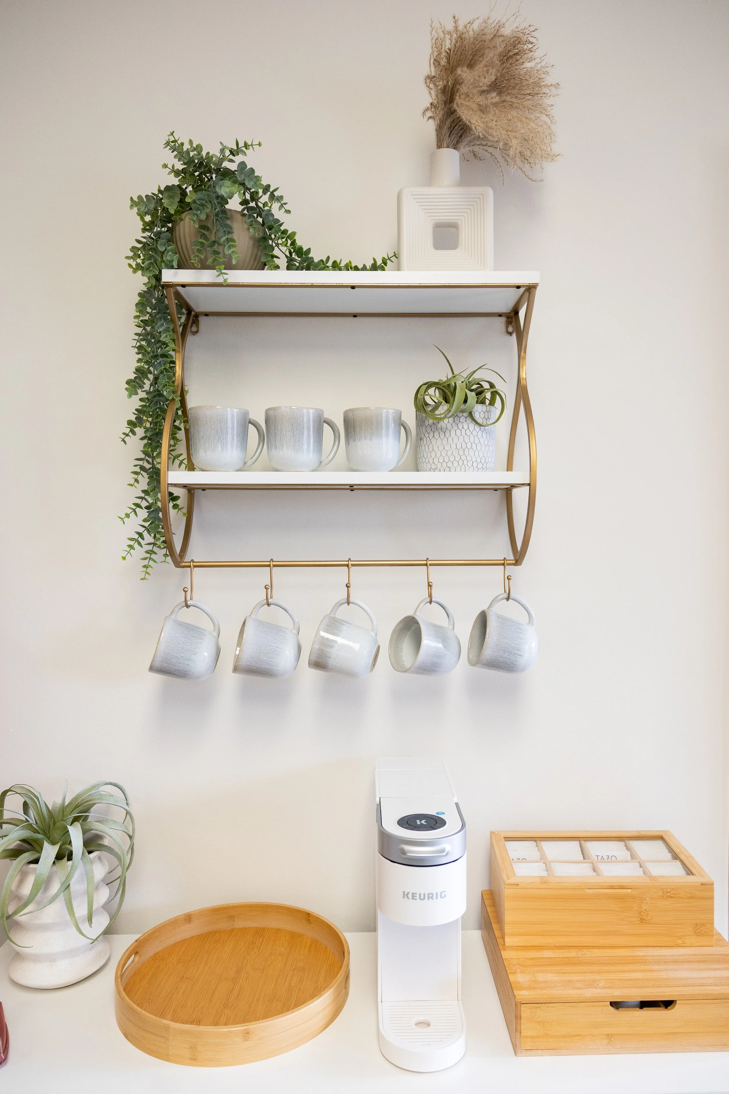 Kitchen wall shelf with plants, coffee mugs, and decorative items at our safe and supportive counseling environment in Bellevue for healing and growth.