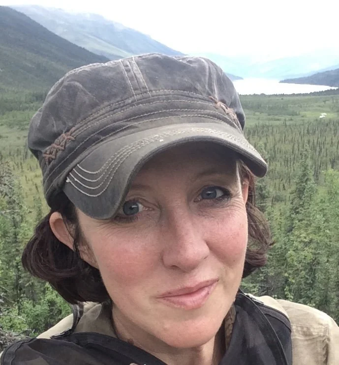 person looking into camera wearing a hat