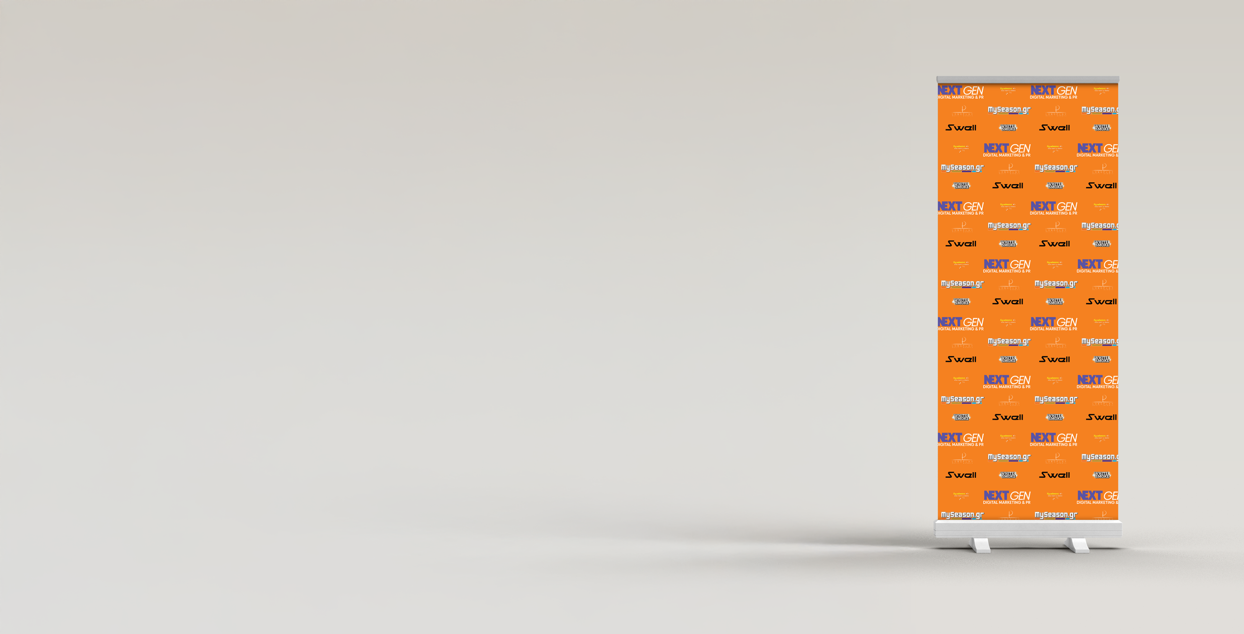 An orange promotional roll-up banner with multiple brand logos and text, standing on a light gray surface against a plain gray background.