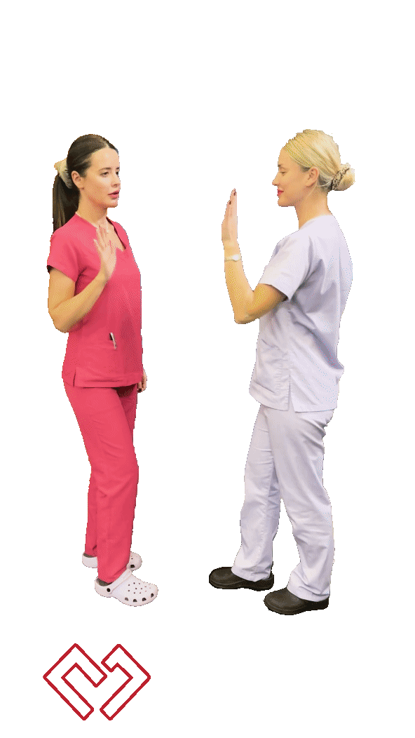 Two female nurses in pink and white scrubs having a discussion with their hands raised, standing in front of a black background, with a Mantalos Plastic Surgery logo at the bottom. mantalos plastic surgery