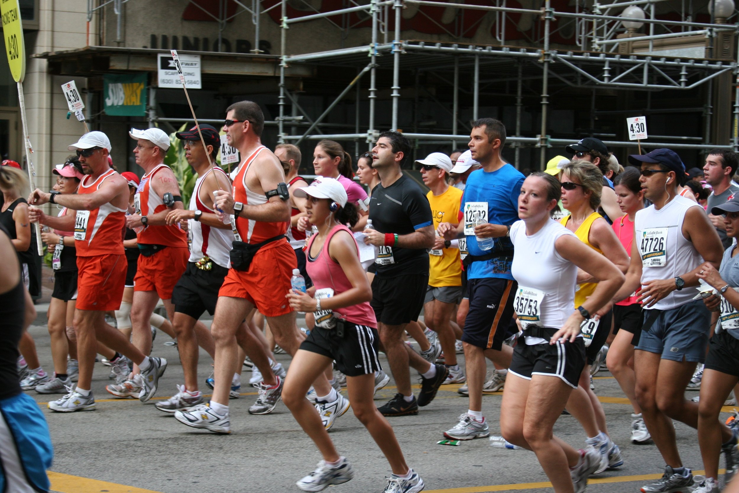 Group of marathon runners participating in a race on a city street.
