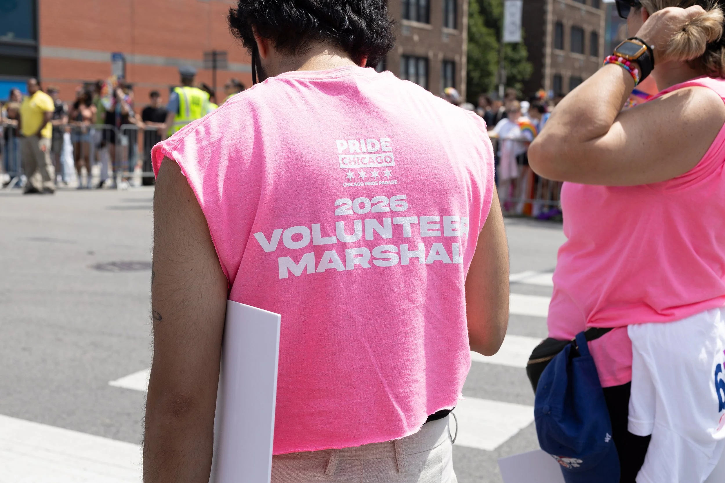A person wearing a pink shirt with 